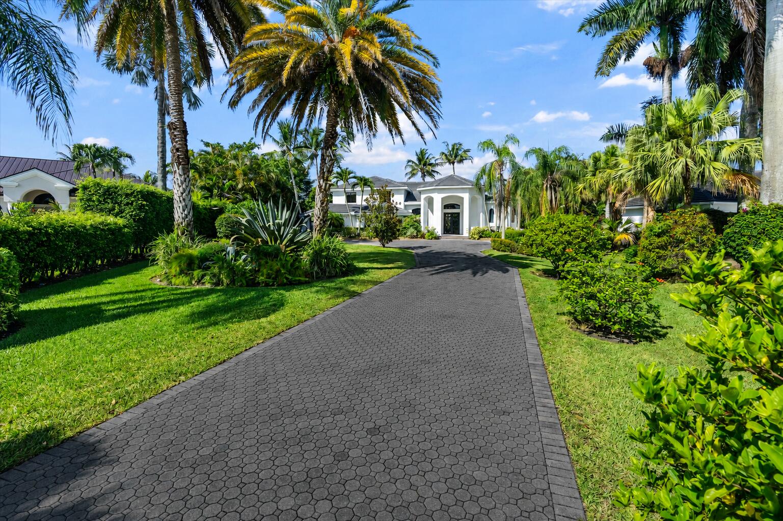 Set on a sprawling one-acre parcel at the end of a cul-de-sac, this completely renovated 5 bedroom home is situated on the best lot in the highly desirable gated community of Delray Lakes Estates. Features include grand covered entry, volume ceilings, double-height great room, 8' doors, glass railings, 4' x 4' tile main floor, and gorgeous white oak hardwood flooring on the second floor. The chef's kitchen features Subzero and Wolf appliances, a massive waterfall-edge island, and a stone hood. The formal dining room is a showstopper with tray ceilings , anchored by a built-in bar with wine fridge, topped with backlit Cristallo quartzite. Functional layout with walk-in pantry and laundry/mud room off the 3 car garage.  All new Delta plumbing fixtures and Toto toilets.   Zoned for Sunrise Park Elementary- a 10/10 rated school.    The cabana bathroom features glowing agate countertops, and offers direct access from the backyard for effortless outdoor entertaining. Outdoor space like this is exceedingly rare in South Florida — a covered lanai, stunning pool and spa, a trellis lounge area, an outdoor beverage bar, travertine pavers, outdoor shower, and a massive yard, all within a private, gated setting. A 3-car garage completes the package. Additional recent upgrades include a brand new roof (2025), all new impact windows and doors, a new pool heater with wireless control, all new LED recessed lighting throughout, freshly painted exterior, and brand new gutters. This is the total package — a home where no detail has been overlooked and nothing is left to do but move in and enjoy.