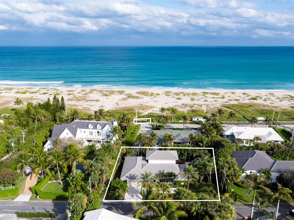 After an extensive 18 month renovation, this Northend four bedroom home with direct access to a private deeded beach parcel is now ready. Completely renovated and redesigned from the ground up, this property features new high-end impact windows and exquisite hardwood floors throughout, as well as a large open kitchen with custom wood cabinetry and upgraded appliances. This home has been professionally decorated and furnished by a renowned Palm Beach designer. The landscaping prioritizes the privacy and seclusion of residents within a friendly and safe neighborhood. This home combines contemporary style and traditional elegance to appeal to today's buyers. Amenities include a ground floor master suite, two additional bedrooms, (each with its own bath), an eat-in kitchen with custom made cabinets, large dining room / living room, two car garage as well as a very large second floor which can be an additional master suite, an in-law suite, or an incredible home office. The property currently exceeds all Palm Beach code requirements for electric, plumbing, and irrigation.
The residence is located on a quiet street and features a walkway accessible from the side yard that leads to your own 35 foot parcel on the beach, where you can create your dream cabana, perfect for Palm Beach entertaining on the ocean. After a day at the beach, leave your paddleboard and beach chairs, and walk back down the private path to relax in the a newly updated in-ground pool - conveniently located just off the the ground floor living area, with an additional separate entrance to the master suite. This gorgeous Palm Beach escape awaits you and your family.