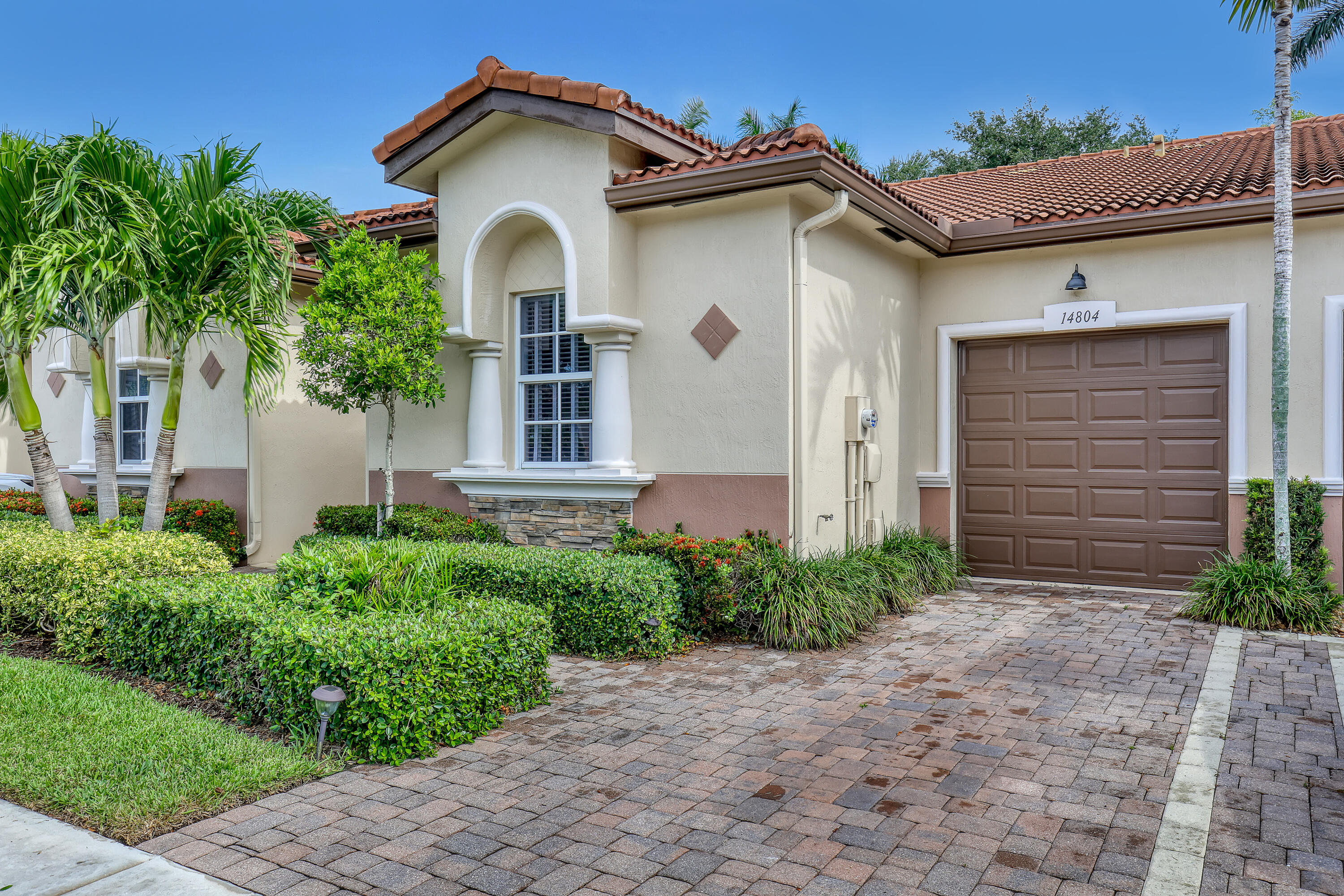 Discover maintenance-free luxury in this beautifully appointed 2-bedroom, 2-bathroom villa located in the highly sought-after Villaggio Reserve.This home features a bright, open floor plan with high ceilings and neutral tile flooring throughout the main living areas. The gourmet kitchen is a chef's delight, equipped with granite countertops, stainless steel appliances, and custom wood cabinetry.Retreat to the spacious primary suite featuring a walk-in closet and a spa-inspired ensuite bath with dual sinks and a glass-enclosed shower.Enjoy your morning coffee on the private, screened-in patio overlooking lush tropical landscaping.Complete with a 1-car garage,impact windows for total peace of mind. HOA fees cover lawn care, cable, and alarm monitoring. Den could be converted to 3rd bedroom.  Villaggio Reserve offers unrivaled amenities including a 38,000 sq. ft. clubhouse, four pools, pickleball and tennis courts, a fitness center, and an on-site café. Located just minutes from the Turnpike and the vibrant dining of downtown Delray Beach.