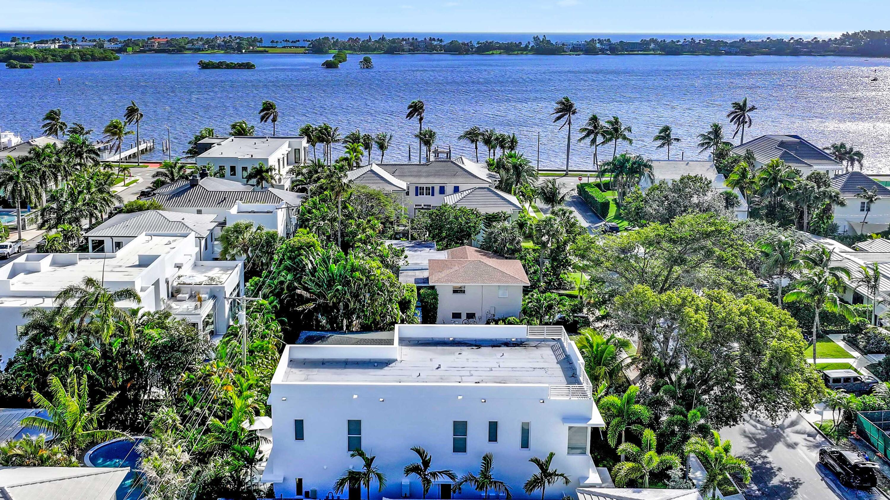 BRAND NEW 2024 CONSTRUCTION ON THE INTRACOASTAL BLOCK! This exceptional 4-bedroom + office, 5.1-bath home spans 4,200+ SF, offering seamless indoor-outdoor living space. Designed with sophistication in mind, it boasts stunning light oak hardwood floors, top-of-the-line Thermador appliances with a gas range, a spacious butler's pantry, and custom-designed closets. Also features expansive windows and sliding doors that overlook the pool area, filling the space with natural light and creating a bright ambiance. The thoughtfully crafted outdoor space features a beautifully designed loggia, with a heated pool and spa. Ideally located in the sought-after 'SOSO' neighborhood, just minutes from Palm Beach Island, PB International Airport, and The Square/CityPlace. Surrounded by top-rated public.. and private schools, this is a rare opportunity to own in one of Palm Beach's most coveted locations!