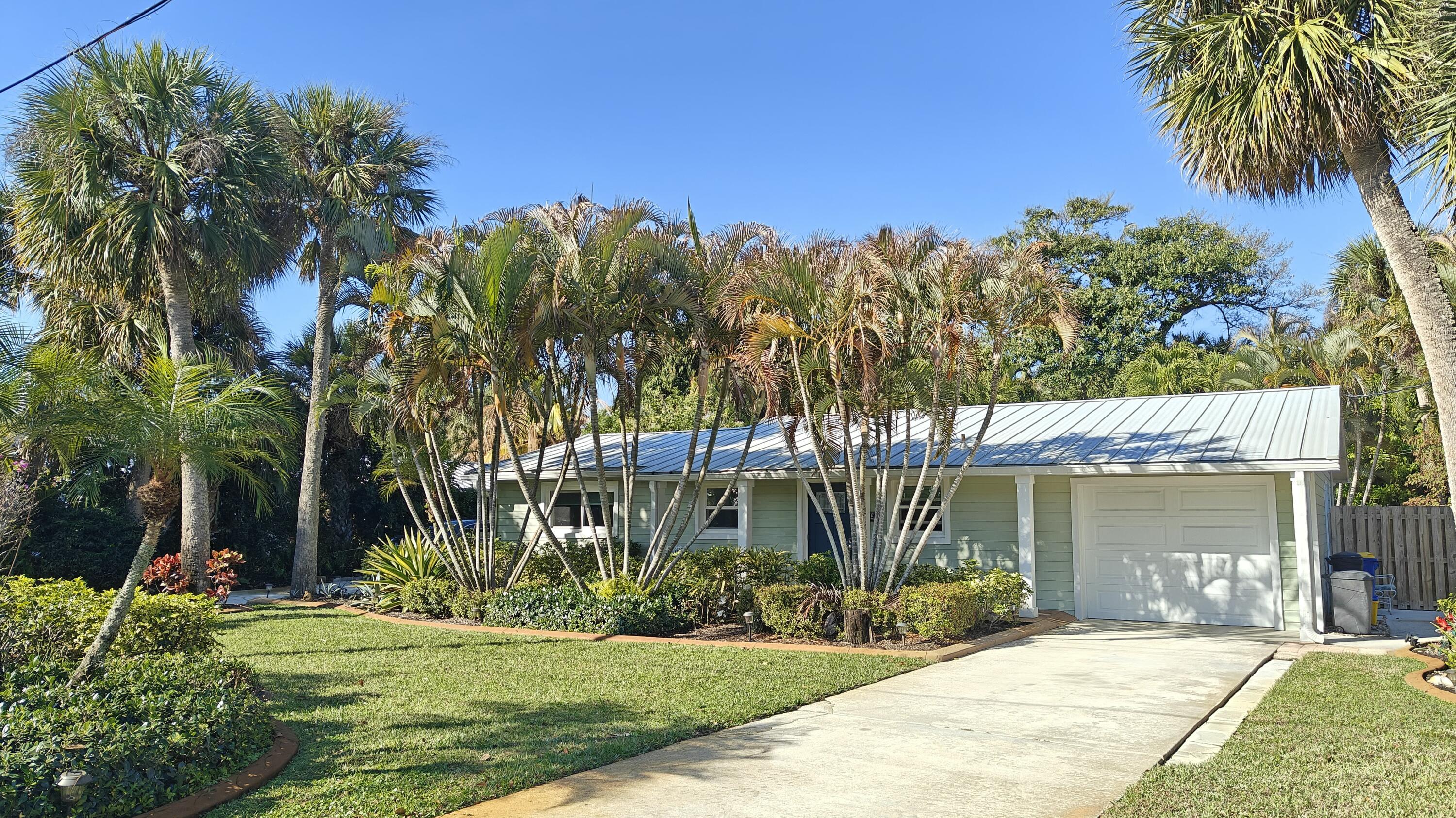 Welcome to your own private tropical retreat in the heart of Stuart! This charming Key West-style 2-bedroom, 2-bath home is tucked away in one of Martin County's most desirable neighborhoods, offering the perfect blend of privacy, comfort, and Florida charm.  Surrounded by lush, beautifully landscaped grounds, this property feels like a serene oasis. The sparkling 12x18 pool creates the ultimate backyard escape ideal for soaking up the sun or entertaining family and friends.   Inside, you'll find an inviting open-concept floor plan designed for easy living. The updated kitchen, featuring newer appliances (2021), flows seamlessly into the main living areas, making hosting effortless A spacious Florida room/family room provides versatile bonus space; perfect as a home office, media room, or additional gathering area.  Thoughtful upgrades add peace of mind, including:  New roof and gutters (2021) - Impact windows and doors (2021) -  Water heater (2020) - Washer and dryer (2021) - Durable Hardi Plank siding  Additional highlights include a large 14x20 shed with electric, ideal for a workshop, studio, or extra storage; two driveways, one extended to accommodate a boat and/or RV.  Conveniently located just minutes from downtown Stuart's charming shops, restaurants, beaches, and hospital, this exceptional property offers the very best of coastal Florida living; privacy, functionality, and timeless style all in one beautiful package.