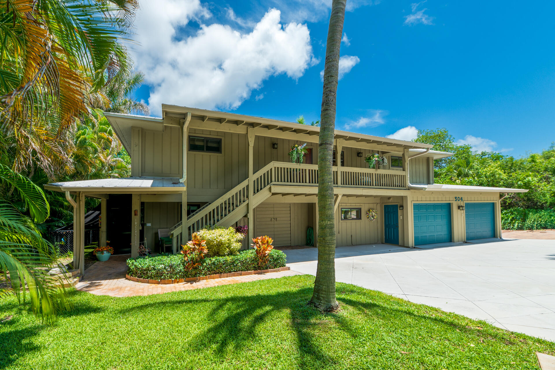 Waterfront living on Poppleton Creek just minutes from downtown Stuart, shopping, dining, and entertainment. This updated 4BR/3BA home offers a private dock, RV parking, and an air-conditioned 4-car garage with epoxy floors. The lower level features a separate-entry guest suite with its own kitchen, living room, bedroom, walk-in closet, and full bath—ideal for guests, extended family, or potential rental income. Upstairs boasts vaulted ceilings, wood flooring, impact windows, spray-foam insulation, a metal roof, updated kitchen and baths with custom cabinetry, oversized island, and a spacious primary suite. Enjoy tranquil water views from the expansive two-story screened porch. Additional features include a swim spa, tankless water heater, and buried 200-gallon propane tank. Move-in ready