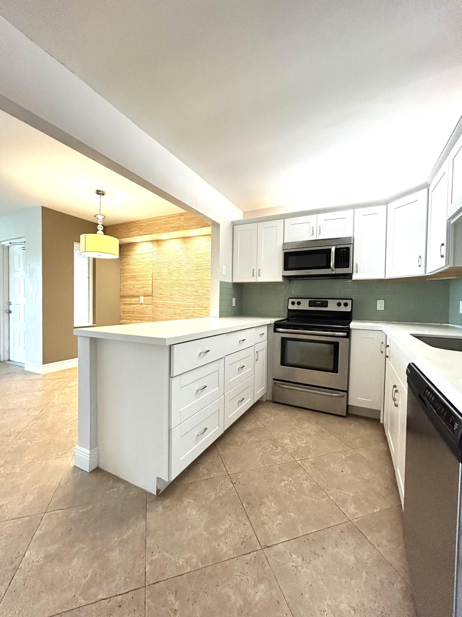 Great Condo! This 2-Bedroom, 2-Bathroom on the 1st floor offers privacy, natural light, and a lakeview. The spacious layout includes a patio perfect for enjoying your morning coffee. The unit is well-maintained and move-in ready, perfect as a primary home, or vacation property. A/C 2024, Roof 2024 The lush community features two pools, tennis and pickleball courts, and more! Located near Dunkin Donuts, Starbucks and more. Go east or west on Atlantic Avenue and you'll be sure to find shopping, activities and more. Close proximity to FL-Turnpike or I95