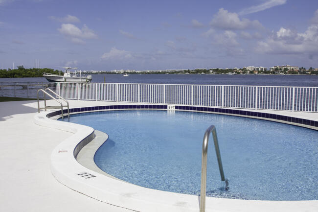 Elevated on the 4th floor along wide Intercoastal waterway this fully reimagined 1-bedroom, 1-bath residence captures sweeping direct Intercoastal water, city and sunrise views from every angle. Thoughtfully redesigned with a refined, neutral palette, the home features a custom high-end kitchen, bathroom, and seamless flooring throughout. Positioned just moments from Lantana Beach, Bicentennial Park, and Ocean Avenue dinning and shopping.  Well maintained five story building with marvelous pool & deck directly on intracoastal. Low HOA fees. Close to I-95 and 20 minutes from Downtown West Palm Beach. Direct southeast exposure from balcony. Can be offered furnished for an effortless move-in experience.