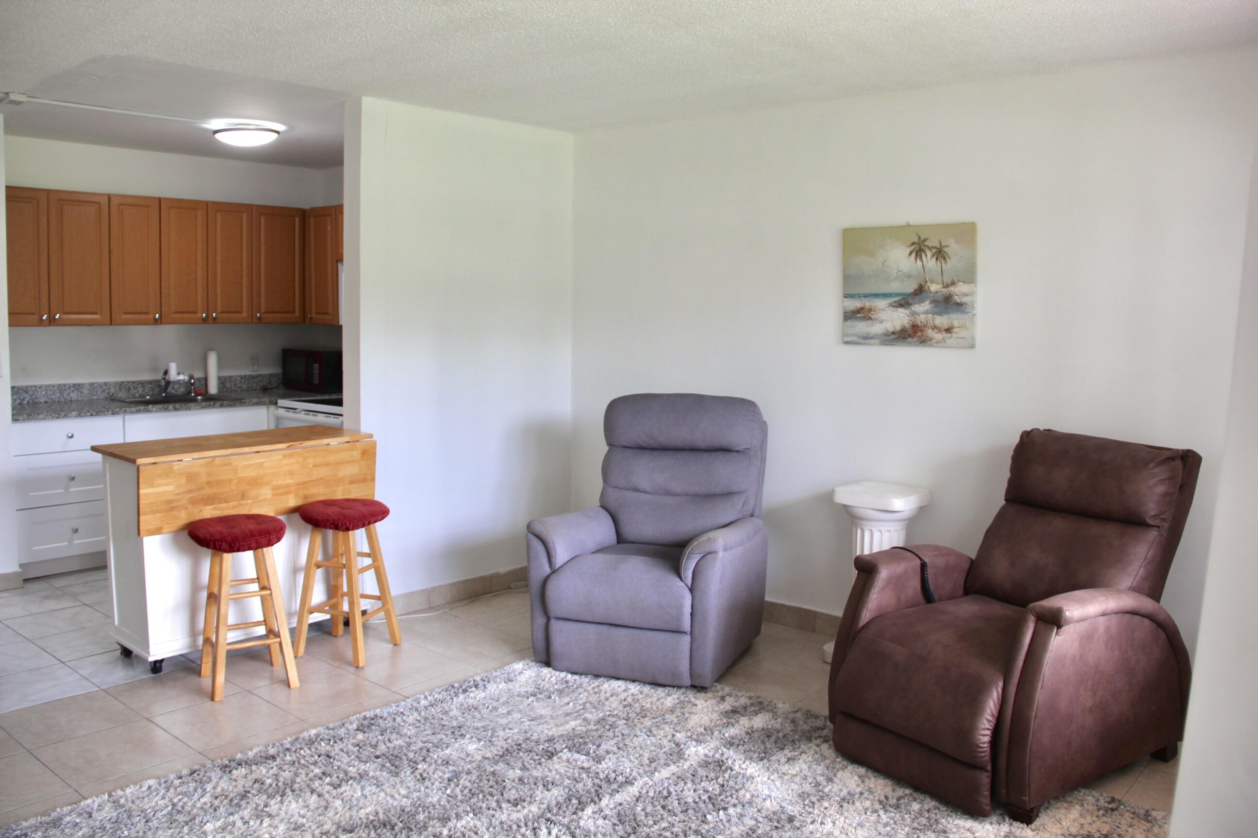 This is a 55+ Adult Gated Community!, CENTURY VILLAGE.  Enjoy a first floor lifestyle in this updated 1 bedroom, 1 bath condo featuring easy care flooring and two window A/C units. The unit is fully furnished (furniture can stay or go) and thoughtfully modified for wheelchair accessibility — the bedroom and utility closet doors were removed to allow easy mobility but can be reinstalled if desired.  Relax on the screened patio, perfect for morning coffee or evening breezes.  Experience the best of active adult living — affordable, accessible, and move in ready. Includes cable (internet and water not included).