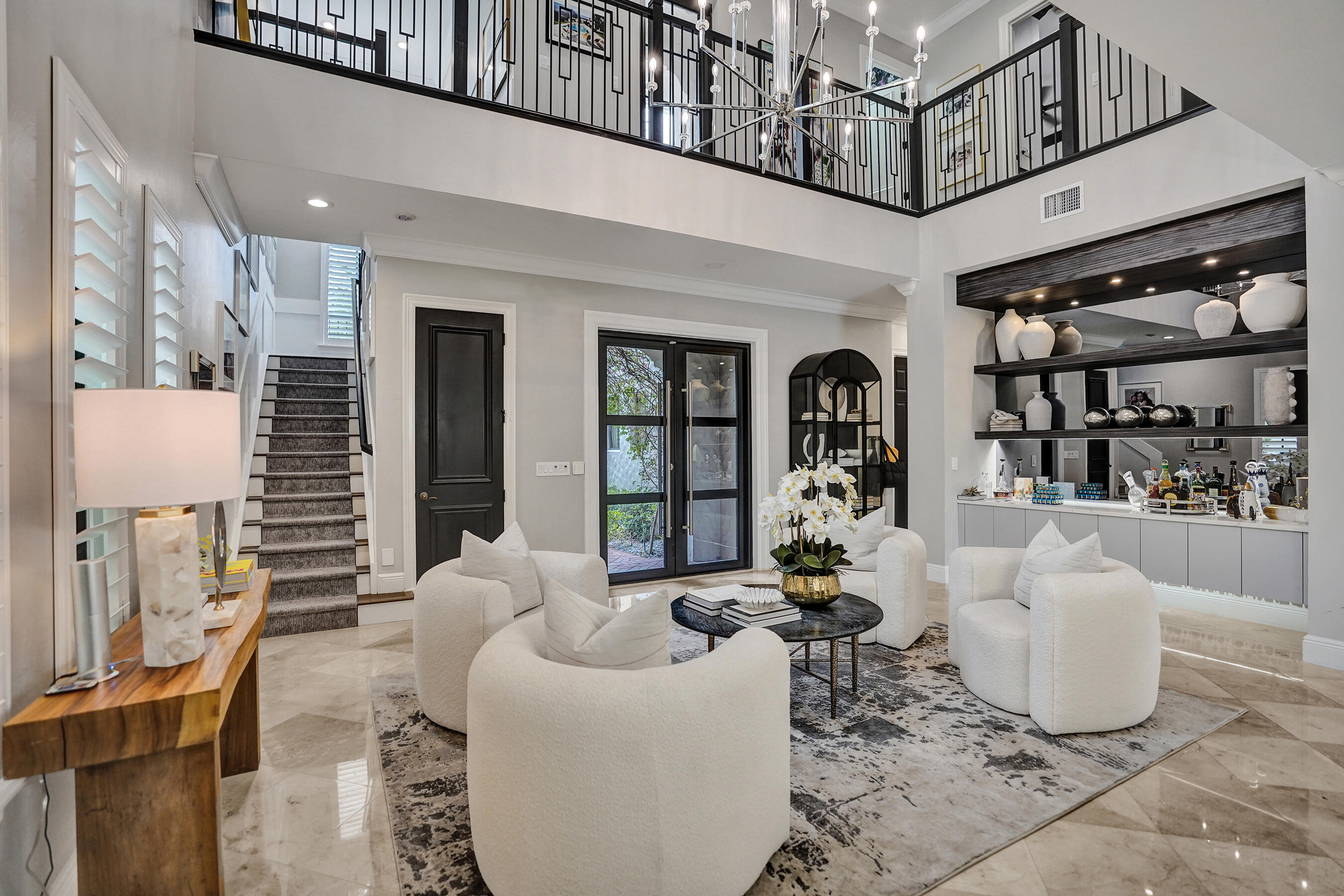 Welcome to luxury living in Parkland's premier community! This fully remodeled 4BR/3BA home perfectly balances modern elegance and functional comfort. The expansive open floor plan showcases contemporary tile floors, recessed lighting, and a chef's dream kitchen outfitted with quartz counters, stainless appliances, custom mirror-tile accents, and a massive island.The primary retreat features custom closets and a spa-inspired bath. Step through the glass doors into your private resort-style sanctuary, featuring a sparkling heated pool, new patio, and beautifully manicured lawn. With a brand-new A/C and new water heater already in place, this turnkey home offers the ultimate South Florida lifestyle.