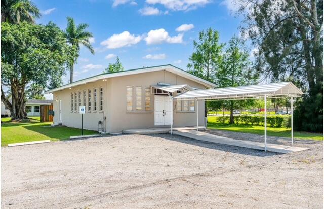 Versatile property with endless potential! Well maintained single building property with open assembly space, kitchen area with plenty of storage and room for seating, two restrooms, and an adjacent lot—ideal for use as a place of worship, daycare, government facility, or redevelopment into two single-family homes. The flexible layout features an open sanctuary/assembly area and functional kitchen. The extra lot allows for expansion, additional parking, or new construction. Centrally located with easy access to main roads and nearby neighborhoods. This property is located directly behind Belle Glade Library. Zoned for multiple uses—bring your vision!