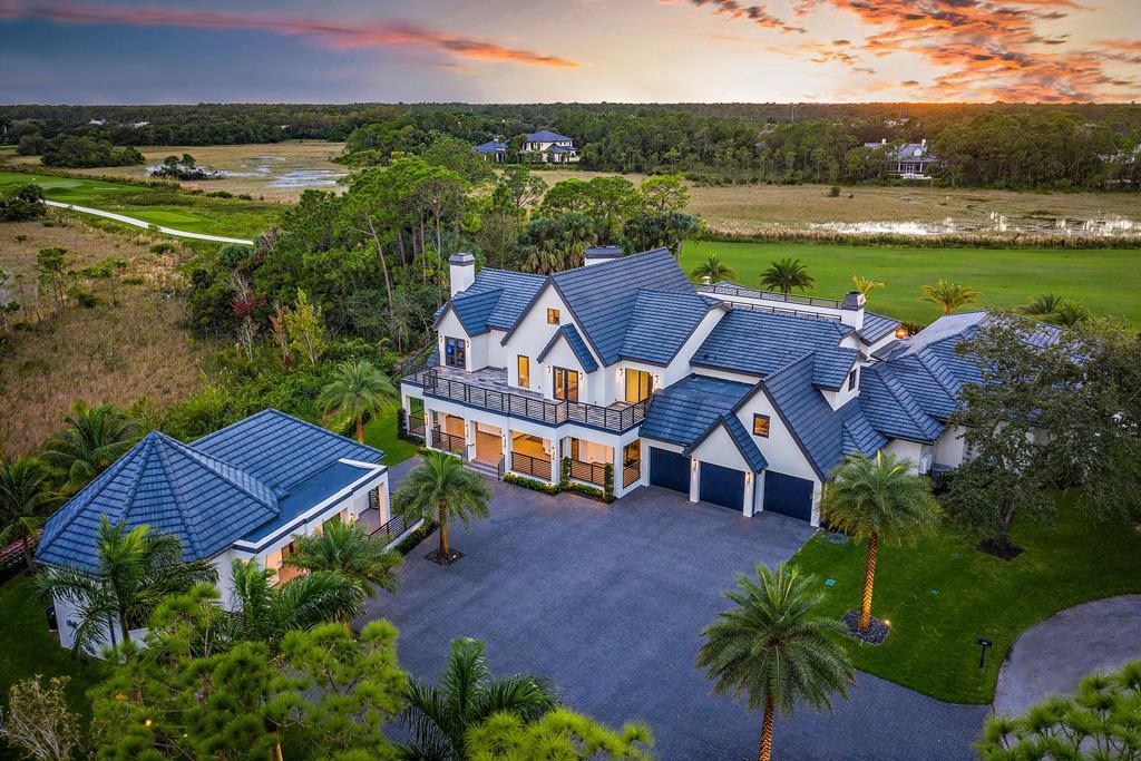 This stunning Old Marsh estate has been totally rebuilt with all the finest custom finishes and appointments. Designed with the perfect combination of entertainment spaces and private retreats. Panoramic golf and preserve views from every room of this privately located double lot cul de sac estate. Filled with extraordinary details for resort inspired living. This home is outfitted with personalized thermostats for all the bedrooms. Spectacular covered and fully a/c'ed loggia with motorized screens for true outdoor entertaining with custom pizza oven, bar and huge sitting area. Stunning resort inspired pool & spa with custom lighting and fire features. Ideal residence for all the modern living needs with a two bedroom plus living area guest house, full gym, media room , wine display & more The first floor features a floor to ceiling granite accent wall, temperature-controlled wine room with space for up to 200 bottles of your favorite wines with full granite wet bar. The modern kitchen includes custom cabinetry, high end Viking and GE appliances, Grohe fixtures and faucet. The master wing of the house offers 3000 sq ft of unparalleled living space. The luxurious bedroom overlooks the resort like pool and golf course offers his and hers dressing rooms that include expansive custom closets and cabinetry with over 20 ft ceilings, his bathroom includes a large walk-in shower. Her bathroom includes a garden tub and large steam shower. . Take the elevator to the 2nd floor which features a home gym with matrix commercial equipment and yoga/martial arts area, a loft that showcases a pool table, mini bar and a home theater with acoustic surround sound. The 3rd floor is a home schoolers sanctuary that includes desks and computers and a full bathroom. Other features include DB4 max sound isolation between the walls and floors, Air purifiers in the air ducts and a steam shower next to the gym. Take a step outside to sit by the pool or lounge in the 1100 sqft of outdoor air conditioned living space. The outdoor patio and bar area with vinyl roll down windows includes a full outdoor kitchen with GE appliances, an Earthstone commercial sized pizza oven, a 45in ProFire built in grill, 3 TVs, a gas fire conversation table, a custom made granite table that seats 12, a wrap around bar that seats 10 and a full cabana bath with shower and locker room. The over sized salt-water pool is heated by a commercial heater and includes water features, accent fire bowls and a spa. The outdoor space is also protected by mosquito repellent so you can use your outdoor space into the night! Separate from the main house is a guest house with 2 separate living spaces. The first living space is set up with a bedroom and full bathroom with a spacious family room and full kitchen. The 2nd space is a quaint 1-bedroom, 1 bath studio. You will fall in love with this sprawling estate home and the elegant and well-crafted features this home has to offer. Set up your appointment today to view this piece of Florida paradise!