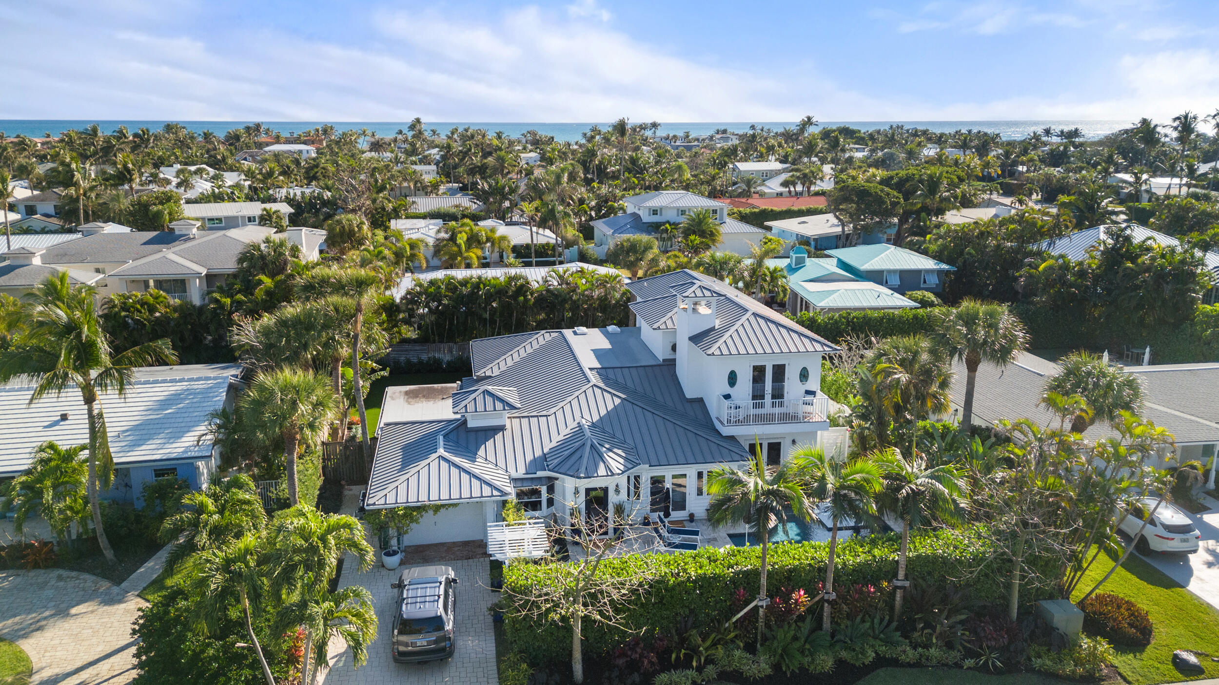 If character, charm and location are high on your priority list, you must visit 122 Lighthouse Drive, located in the desirable enclave of Jupiter Inlet Colony! The 3,800 sq ft home features classic finishes throughout and has been has been lovingly cared for by the current owners. Countless design features include a secluded, spacious upper level master suite, complete with a view of the Jupiter Lighthouse, high ceilings, a jacuzzi tub and separate shower. You'll feel at home upon entry, with high ceilings and authentic pecky cypress beams, an open kitchen concept, and family room with gas burning fireplace. Dining experiences will be elevated in the home's formal dining room, made cozy with pecky cypress ceilings and anchored by a temperature controlled wine room, just a couple steps away For those loving a great outdoor experience, the custom, tropically landscaped yard is here for you. The new in-ground pool features a salt system, water features and gas heater. Artificial turf in the front and back finish the space beautifully and are ready for your outdoor furnishings. The new owner will be pleased with the new roof, generator and updated appliances.