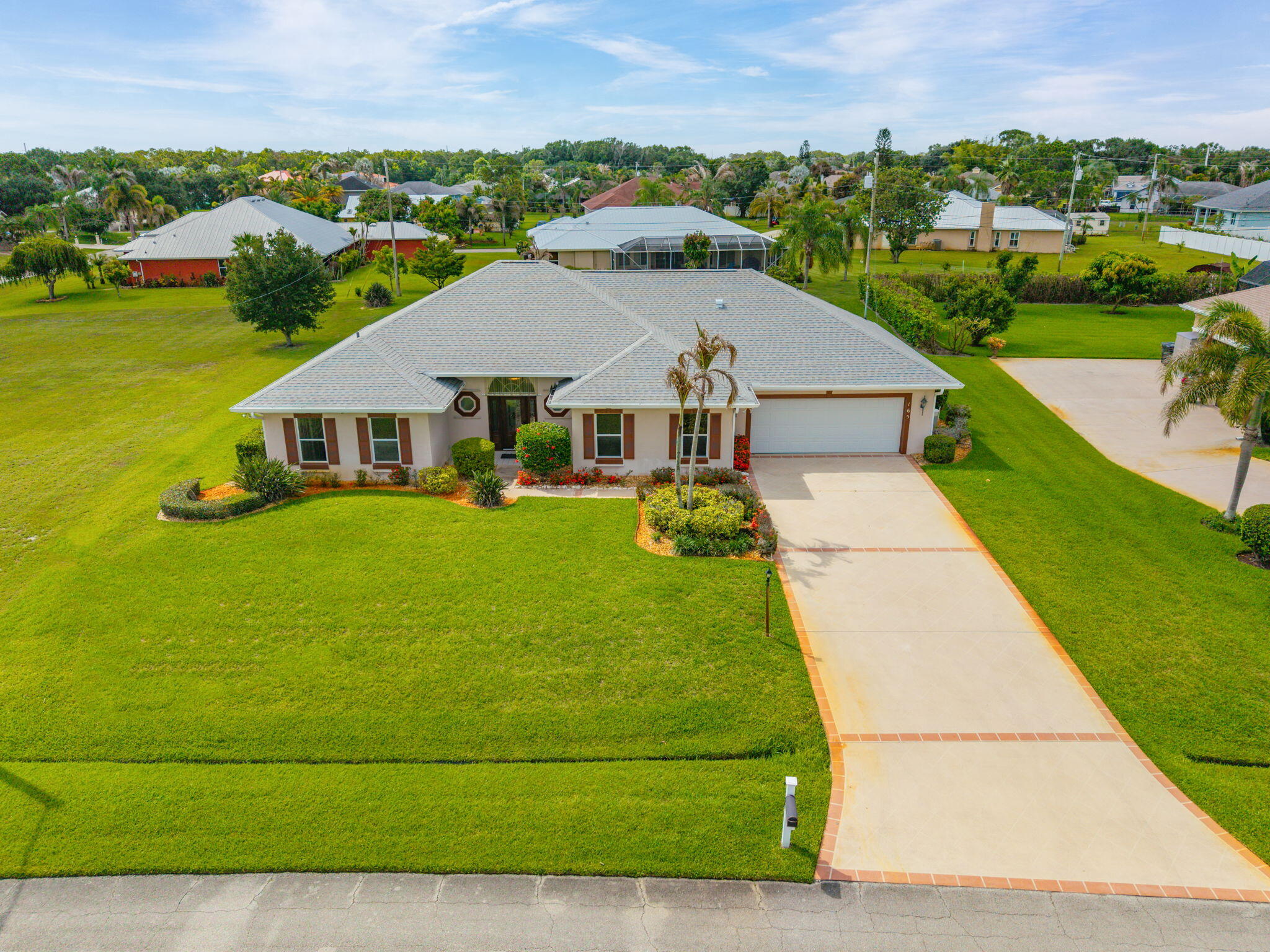 Welcome to your beautifully updated Florida retreat! Recent updates include: NEW ROOF, gutters, flooring, quartz countertops, stainless steel appliances, total bathroom makeovers including stunning tiled showers and freestanding tub, fixtures, interior paint throughout & so much more.  This 4 bed, 2.5 bath pool home with relaxing spa is just minutes from Port St Lucie's best shopping, dining, and breathtaking beaches. Set on a generously sized lot, this home offers a spacious layout, separate office space, oversized garage with additional golf cart storage and full-house storm shutters. The large screened lanai is perfect for poolside gatherings or simply soaking up the sun. Move-in ready and waiting for new owners to create lasting memories! No HOA. Buyers to verify measurements
