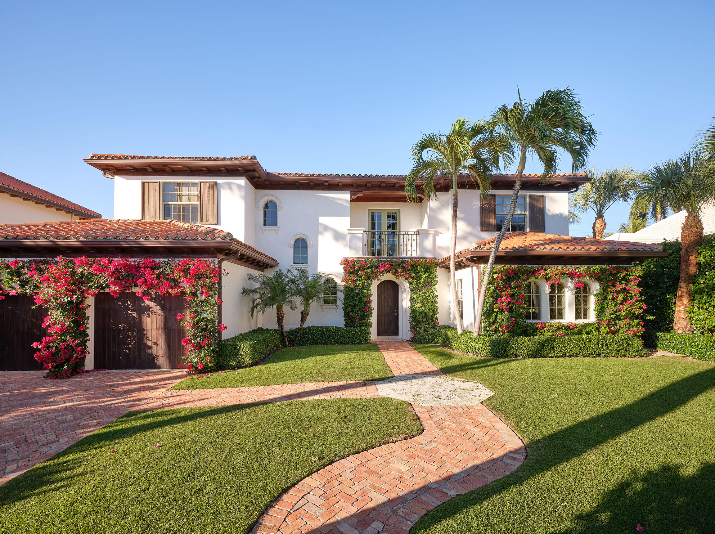 Beautifully reimagined and thoughtfully designed, this exceptional residence is perfectly positioned on one of the premier lake blocks in West Palm Beach's coveted SoSo neighborhood. Built in 2004, the home offers five bedrooms and four-and-a-half baths across 4,567 square feet, set on a generous 10,000+ sq. ft. (80 x 125) lot. The oversized primary suite is a true sanctuary, balancing comfort and practicality. Throughout the home, custom European wallpaper introduces a curated, designer aesthetic. The chef's kitchen, complete with a 60'' Viking range, flows effortlessly into the informal family room overlooking the backyard and pool. Updated Waterworks fixtures bring refined, classic elegance to the baths. Outdoors, the private pool and beautifully landscaped backyard create an inviting setting for entertaining and relaxation. Mature landscaping enhances privacy and curb appeal, completing this exceptional home. Additional features include a two-car garage, generous storage, and quality finishes throughout.