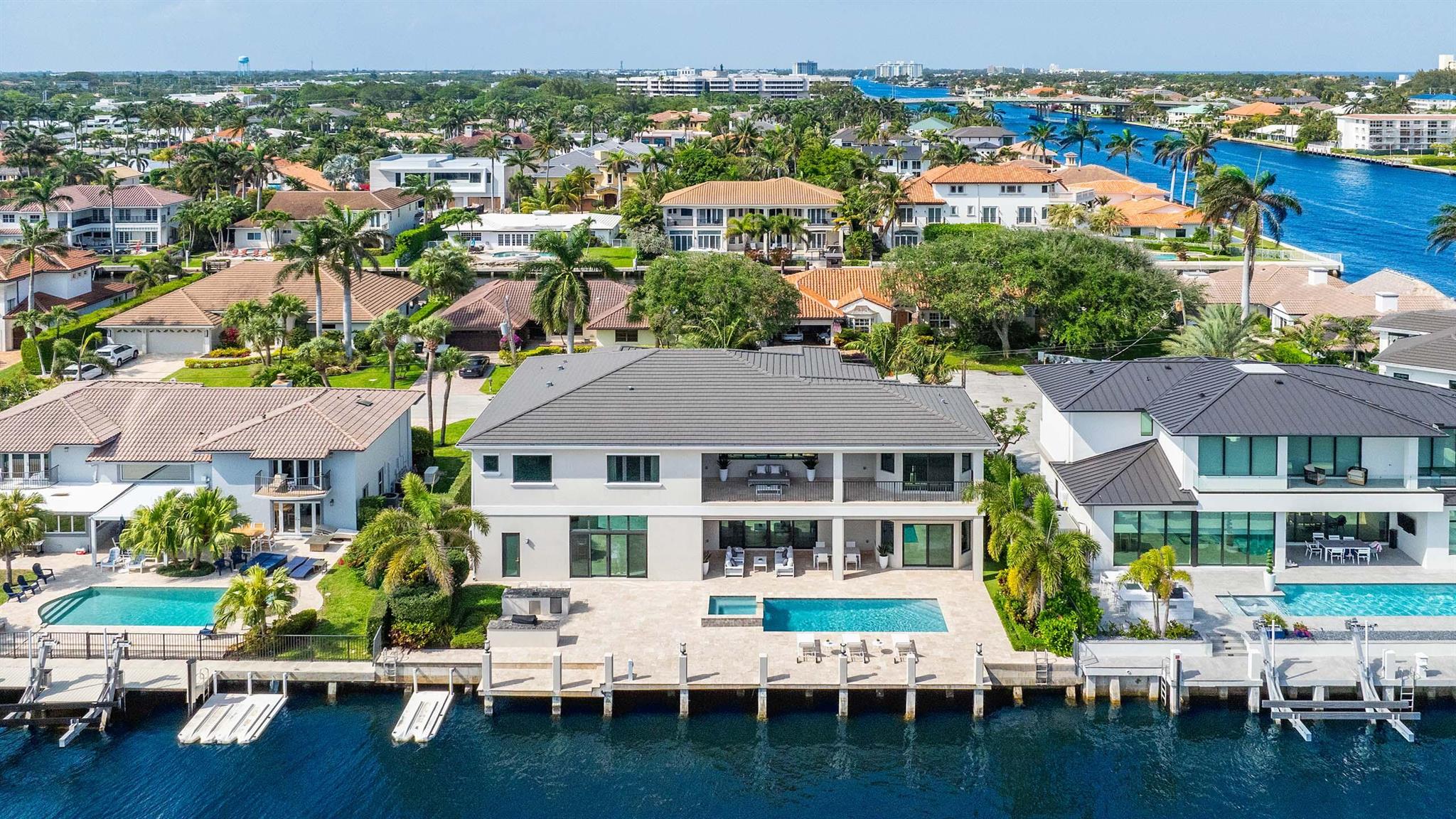 Sensational Tropic Isle home offers 94 feet of waterfrontage with private dock and ocean access via nearby inlets. Situated on a cul-de-sac just two lots off the point, this six bedroom waterfront residence is in pristine condition with high-quality finishes and water views throughout. Boasting 7,784 total square feet and an open floor plan with volume ceilings, the property is ideal for privacy and entertaining alike. Features include walls of glass sliders for easy access to outdoor living areas and the pool; easy flow from living room to kitchen to casual living area; walk in pantry; and three car garage. Enjoy outdoor living with covered loggia and custom electric screens; built-in grill and serving area; waterside patio; and heated pool with spa. Boaters will appreciate the private dock and easy ocean access via nearby inlets. Tropic Isle is located close to shopping, dining and Atlantic Ave. 

FEATURES
" 94 feet of waterfrontage just two properties from the point lot
" Private dock and easy ocean access via nearby inlets
" 5,523 square feet under air / 7,784 total square feet
" 6 bedrooms / 6 full and 1 half bath
" Meticulously maintained with high-end finishes and quality design
" Cul-de-sac location with great curb appeal and decorative circular drive
" Front portico entry leads to double glass door entry
" Volume ceilings and walls of glass sliders provide natural light and easy access to covered loggia
" Open floor plan with views of the pool and water throughout
" Living room easily flows to the kitchen, dining room, and casual living room
" Open kitchen with island; top-of-the-line appliances; wine fridge; snack bar seating; large pantry; and butler's pantry
" Stately staircase with landing and open hallway on second floor
" Primary wing with views of the pool and waterway; morning bar; access to large covered balcony; two walk-in closets; and luxurious bath with tub, shower, and dual vanities
" Five additional en suite bedrooms; one of the ground floor guest rooms are currently set up as an office & den
" Large covered loggia with plenty of room for outdoor living and dining 
" Outdoor built-in grill and serving area with counter space and sink
" Expansive waterside open patio with space for lounging poolside
" Heated salt-water pool with spa 
" Private dock just two lots from Intracoastal with easy ocean access via Boca Raton or Boynton Beach inlets
" First floor and second floor laundry rooms
" Elevator
" Three car garage 
" Impact glass windows and doors throughout
" Generator
" Nearby shops and restaurants and East Atlantic Ave 
" Located between Palm Beach and Fort Lauderdale with 3 international airports and several private airports available

This stunning waterfront residence is in pristine condition and offers the very best in South Florida luxury living.
