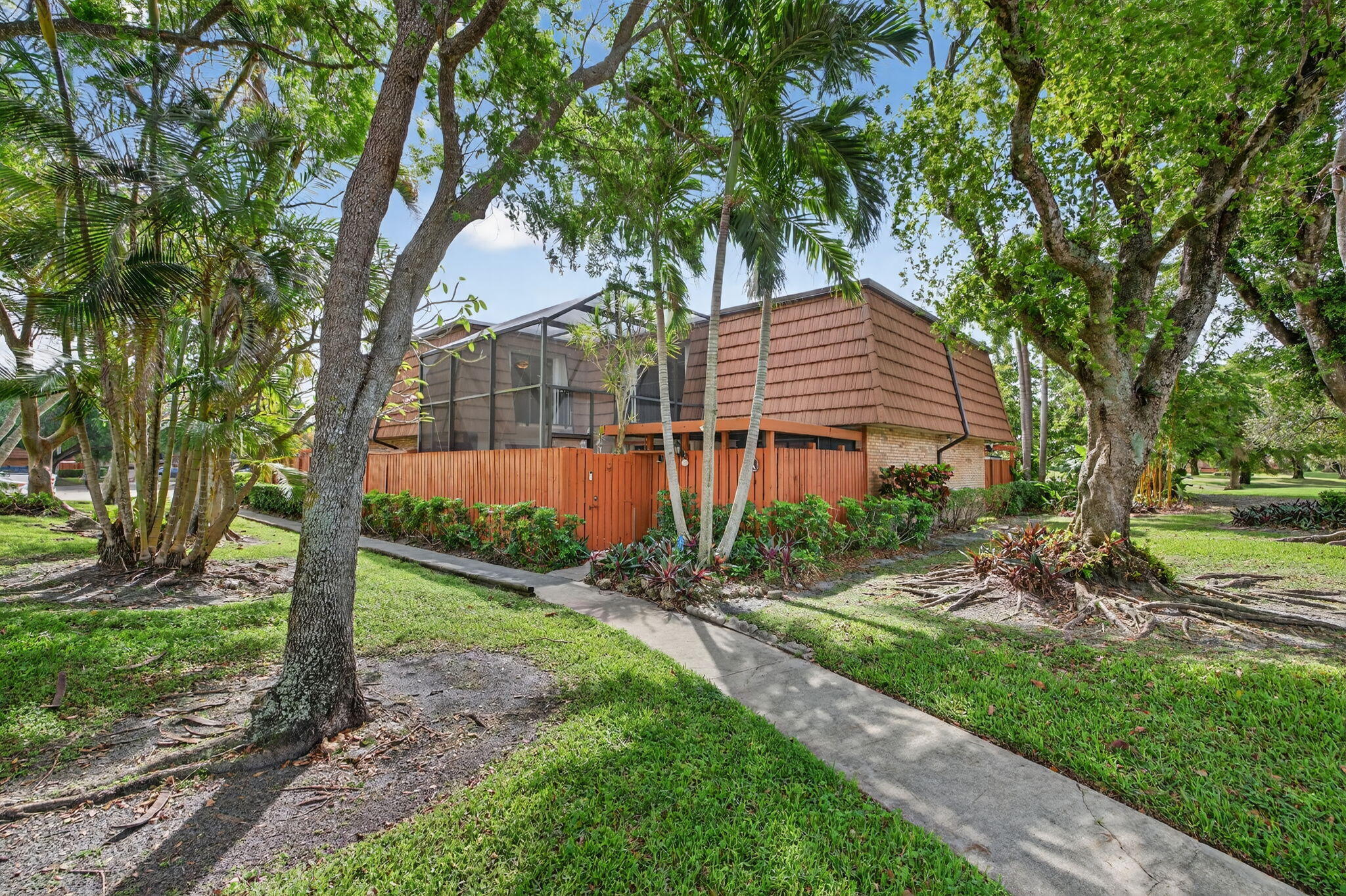 New to market 2BR/2.5BA townhouse in the desirable all-ages RIDGEWOOD community of Pine Island Ridge, in Davie. UPDATED KITCHEN WITH GRANITE, SS APPLS, and generous cabinetry. OPEN OVERSIZED LIVING & DINING AREA offers flex use, with potential for 3rd bdm or office. EXPANSIVE OUTDOOR LIVING AREA IS ENCLOSED BY A DRAMATIC TWO-STORY SCREENED ENCLOSURE, adding true outdoor livability. Upstairs features CERAMIC WOOD-PLANK FLOORING. Both bdrms have Juliet balconies overlooking the enclosed patio. Spacious primary includes a walk-in closet, additional closet, and ensuite bath with dual sinks, shower, and extended vanity. HOA INCLUDES CABLE, INTERNET, & MEMBERSHIP TO PINE ISLAND RIDGE COUNTRY CLUB, with access to clubhouse, htd pool, gym, dining, sports bar, pickleball, plus golf (nominal fees).