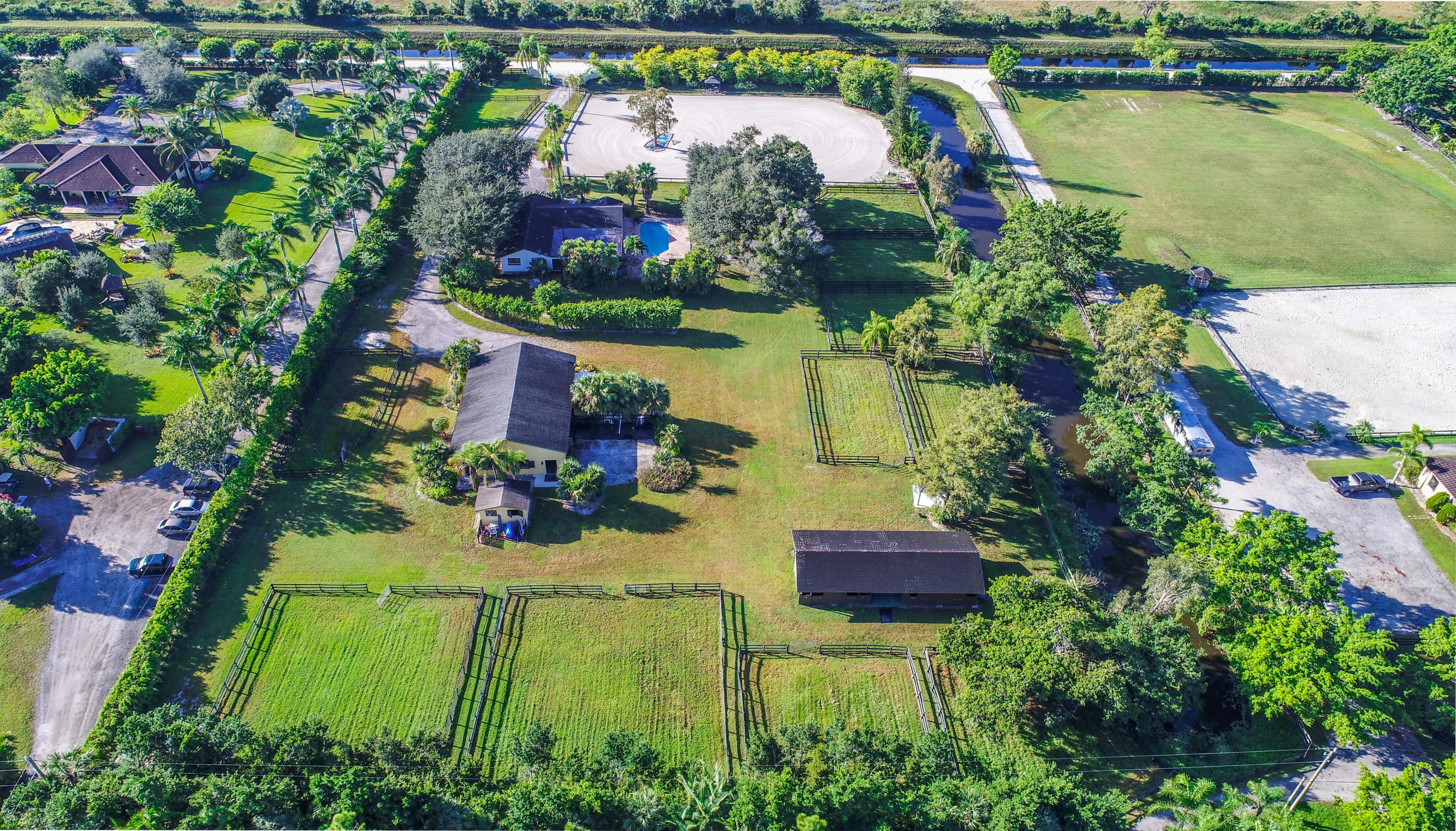 Very private 5 acre property 1 1/2 miles south of main equestrian venues. Turnkey 6 bedroom, 3 bath furnished house with private pool. Equestrian amenities include  220' x 180'  ring. Two barns 8 stalls each, and ample room for temporary stalls.  4 wash stalls attached to first barn, tack room, feed shed,  10 large paddocks.  Maintenance machinery on site.
