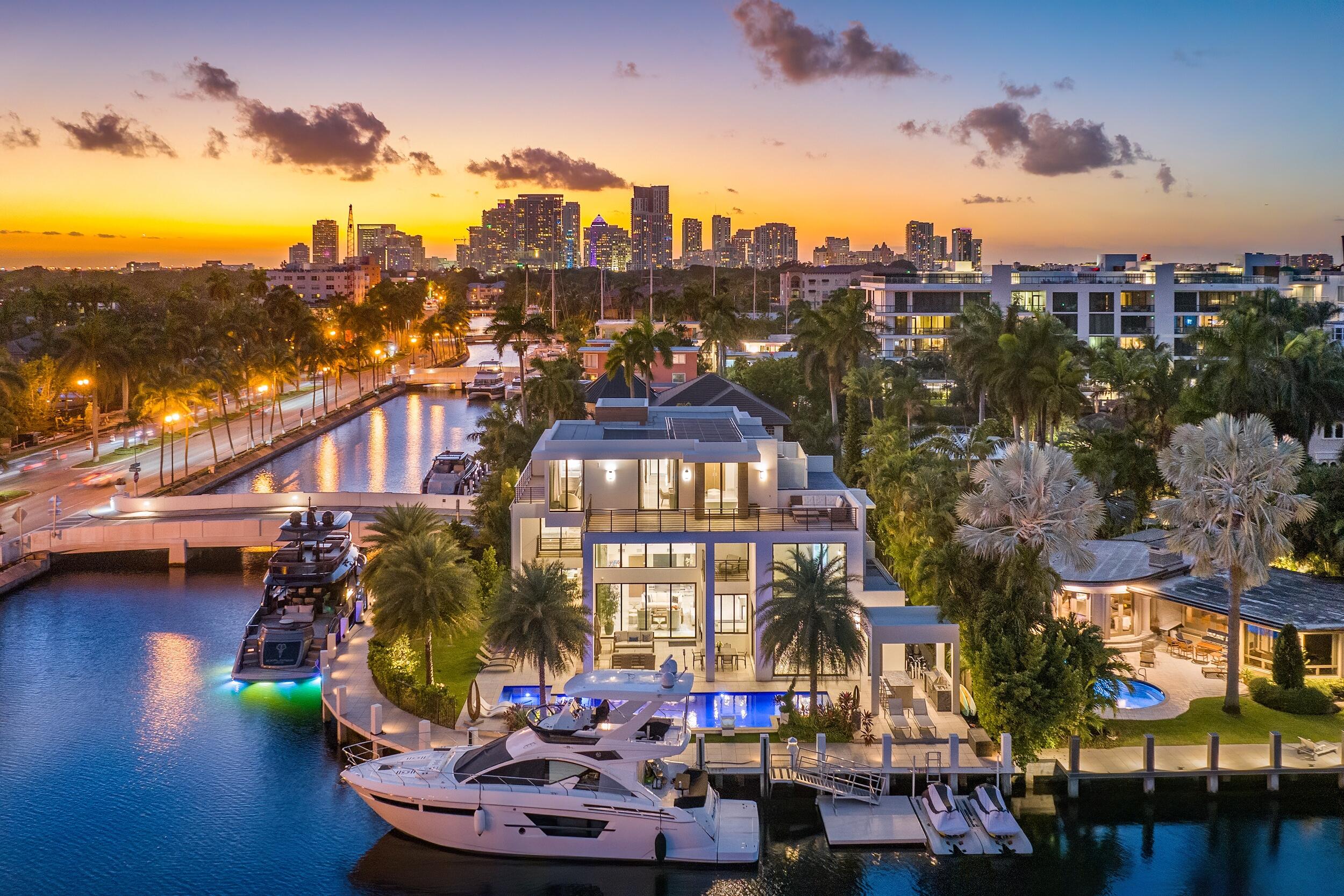 Indulge in the extraordinary at 2 Fiesta Way, where contemporary-inspired opulence redefines the standards of luxury living. This three-story point lot estate seamlessly blends sophistication, design, architecture, and elegance. With a total square footage of 7,661 and an interior space of 5,926 square feet, the estate has 6 bedrooms, 7 full bathrooms, and 1 half bathroom. The residence's allure extends to a remarkable 220-foot concrete dock, catering to the most discerning yachting enthusiasts. 

Upon entering this refined estate, an open-layout design allows the space to fill with natural light through floor-to-ceiling windows. Positioned to the right of the entrance, a sleek glass elevator stands ready to transport guests to all three floors of this magnificent property. The formal living room, with its breathtaking fireplace serving as the centerpiece, not only offers stunning views of the resort-style pool, spa, and waterway but also reaches the second floor, adding a touch of grandeur to the entire estate. The culinary haven, boasting Thermador appliances and a dazzling marble kitchen island, is enhanced by a gleaming glass wine wall perfect for wine connoisseurs seeking both functionality and style.

Ascending to the second floor reveals a VIP Guest Suite and three additional bedrooms with extended views of the first floor, fostering a sense of unity and grandeur. The third floor hosts the primary suite, where luxury reigns supreme with two balconies unveiling breathtaking city and ocean views.
 
The exterior is a masterpiece, featuring a large, covered patio with a summer kitchen, an outdoor cabana bath, and a pristine pool and spa that exude tranquility and leisure. Beyond aesthetics, this intelligent property boasts cutting-edge technology, managing lights, garage doors, shades, pool equipment, a jacuzzi, 8 TVs, 8 outdoor cameras, and music systems seamlessly controlled at your fingertips.
 
Immerse yourself in a world where every detail is a work of art, and every facet is a testament to the pinnacle of contemporary-inspired living. This is not just a residence; it's a transcendent experience in luxury living.

*One bedroom is currently remodeled as the office.