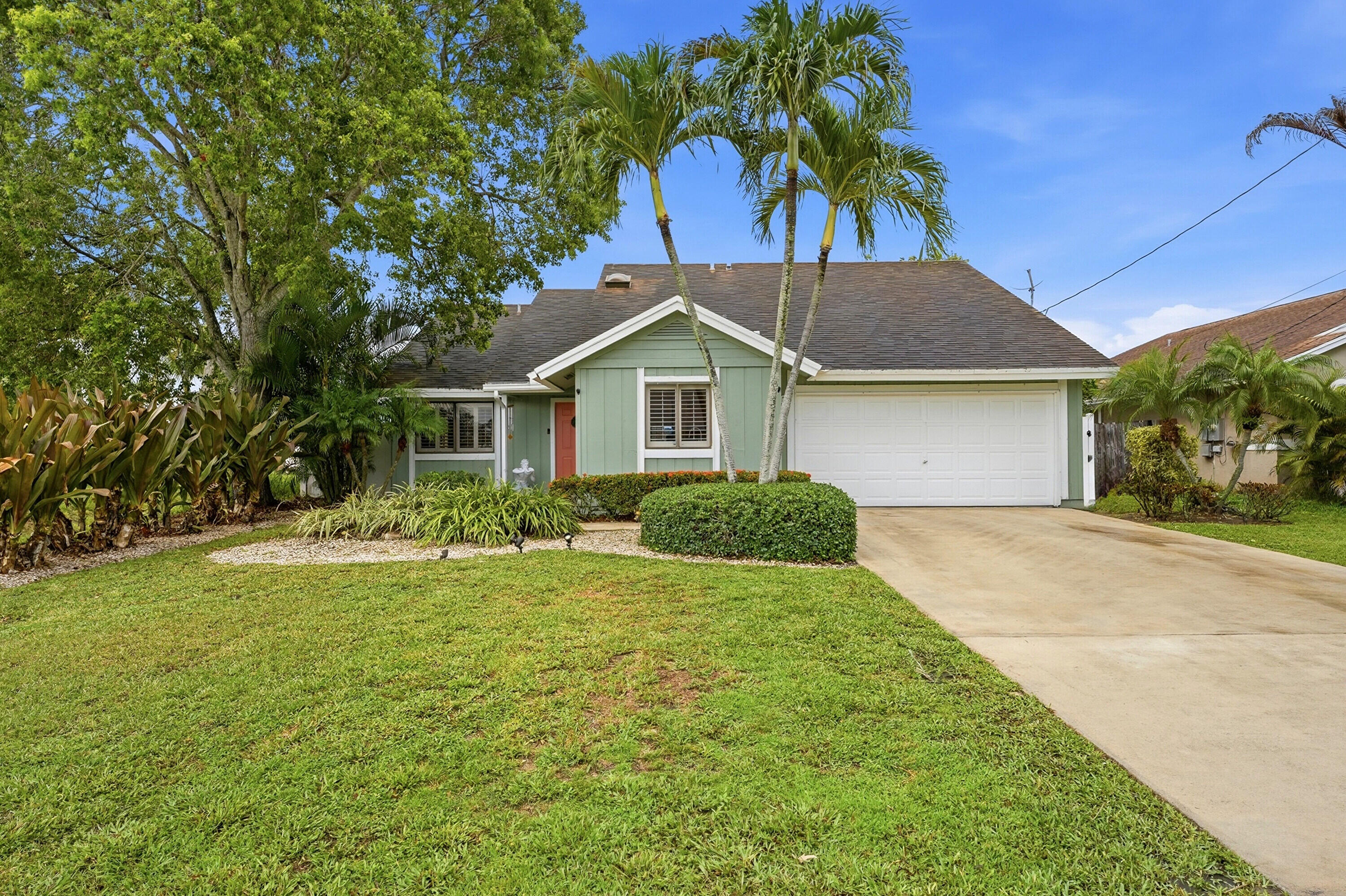 Live the Florida lifestyle in this beautifully updated corner lot home beside a peaceful canal and just steps from a fenced neighborhood park. Enjoy sunny days in your newly fenced backyard with a Diamond Brite pool, lush landscaping, and evening lighting. Inside, vaulted ceilings, wood look tile, plantation shutters, and an upgraded quartz kitchen create a bright, modern feel. The primary suite offers a walk in closet and spa style bath. With full hurricane protection, a two car garage.  This home blends comfort, style, and everyday convenience near Abacoa and local amenities.
