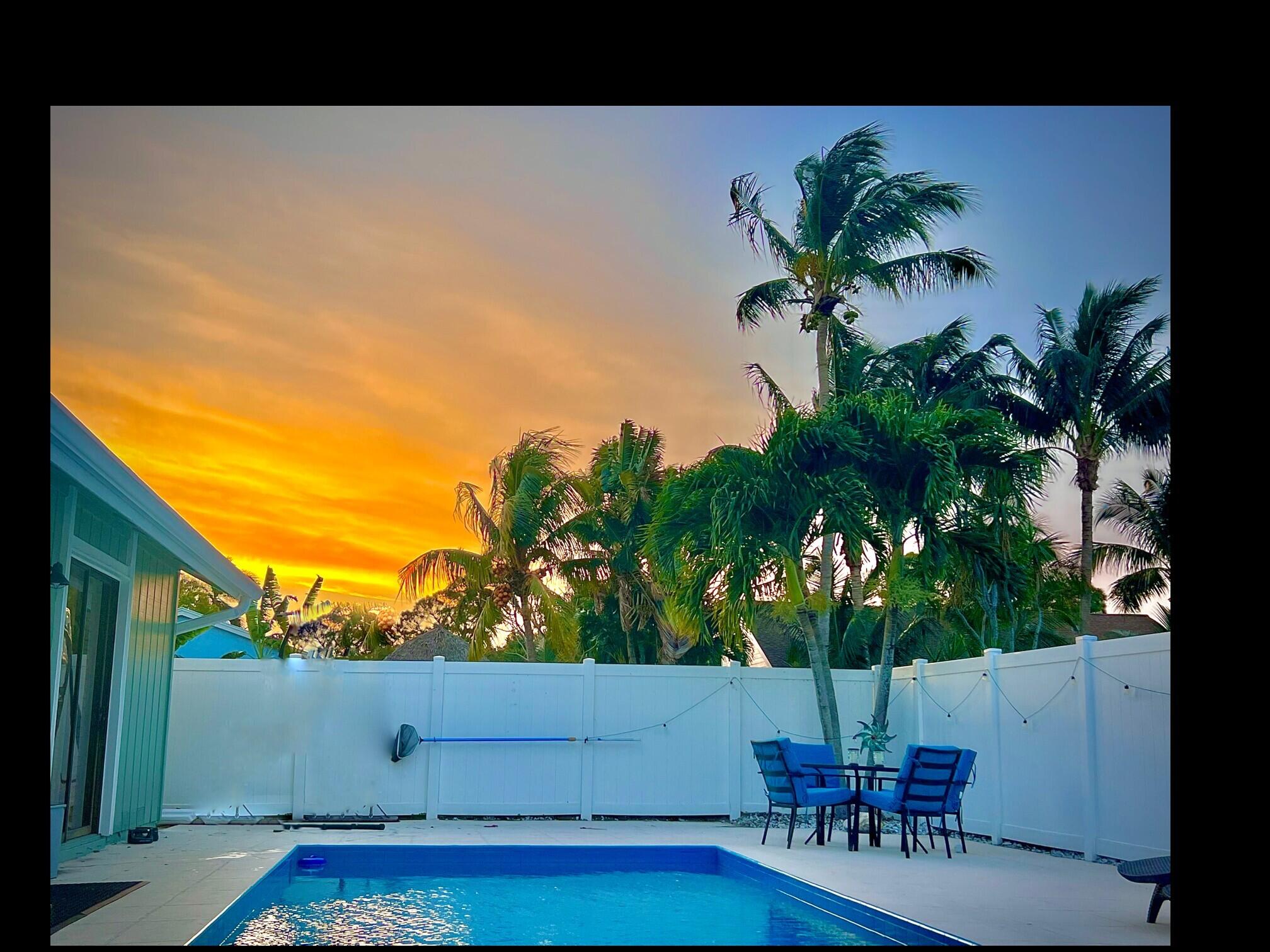 Live the Florida lifestyle in this beautifully updated corner lot home beside a peaceful canal and just steps from a fenced neighborhood park. Enjoy sunny days in your newly fenced backyard with a Diamond Brite pool, lush landscaping, and evening lighting. Inside, vaulted ceilings, wood look tile, plantation shutters, and an upgraded quartz kitchen create a bright, modern feel. The primary suite offers a walk in closet and spa style bath. With full hurricane protection, a two car garage.  This home blends comfort, style, and everyday convenience near Abacoa and local amenities.