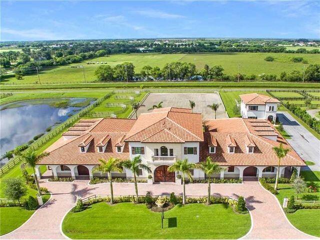 20 Stall training facility in Grand Prix Village South on 3.66 acres, combine with the adjacent 3.4 acres for a prime 7 acre farm next to WEF! The Stable features mirror image wings w/ 2 large tack & feed rooms, 4 wash stalls, vet stall,  laundry room, kitchen area, 2 storage rooms, office & 1 full bath.  Above is a 1 bedroom owner's qtrs. great room style with elevator access and a balcony overlooking the 210' x 120' riding arena and 5 paddocks. The property also has a separate storage building with a 3 car garage and a 2Br staff apartment above. The property is well maintained with easy access to the bridle path and the West Gate out onto 40th Street South to south shore and Lake Worth Rd., allowing you to bypass morning & evening traffic backups on Pierson Rd.