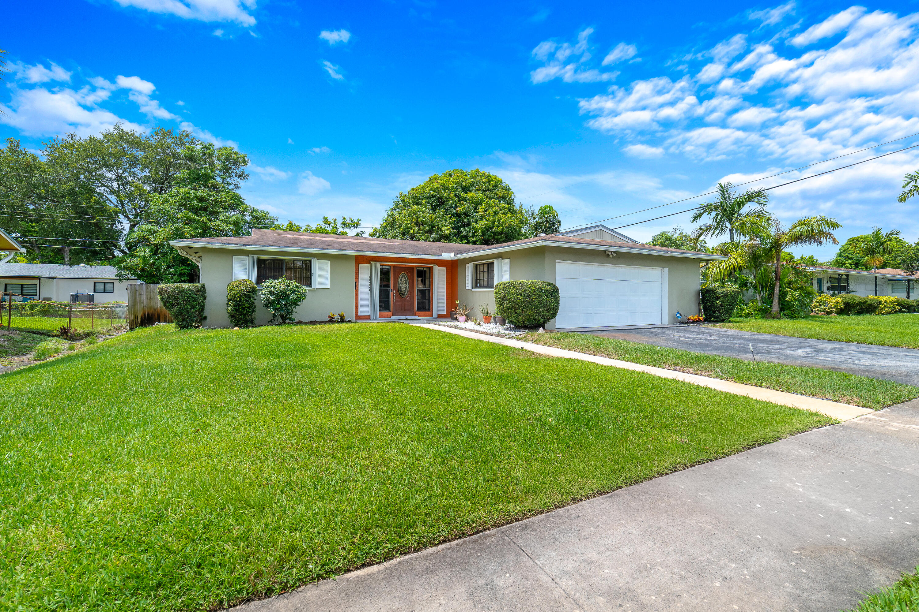Welcome home to this spacious and well-maintained residence in desirable East Plantation, where convenience, charm, and freedom come together with no HOA fees or restrictions. Featuring an attached two-car garage and complete accordion hurricane shutters, this home offers both comfort and peace of mind. Inside, marble tile flooring flows throughout the living spaces, creating an elegant and cohesive design. The updated kitchen is the heart of the home, showcasing granite countertops, beautiful glass-inlaid cabinetry, abundant storage, and a convenient pass-through window that seamlessly connects to the Florida room. An additional dining area in the kitchen and direct garage access add to the home's everyday functionality.  Designed for both relaxing and entertaining, the expansive Florida room is anchored by a charming wood-burning fireplace with a brick hearth, creating a warm and inviting atmosphere during the winter months. The large formal dining area provides ample space for gatherings and special occasions. The thoughtfully designed floor plan includes three generously sized bedrooms, two full bathrooms, and a full-size washer and dryer. Outside, a private patio and fully fenced backyard offer the perfect setting for outdoor dining, pets, or simply enjoying the shade of mature trees on a warm Florida afternoon. Ideally located in East Plantation, you'll enjoy easy access to parks, shopping, dining, major highways, and all the amenities that make Plantation one of South Florida's most sought-after communities. This is an exceptional opportunity to own a spacious home with room to live, entertain, and enjoy the Florida lifestyle.
