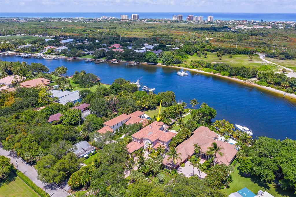 Grand Old Oak trees frame the entrance to this extraordinary Intracoastal estate. This home offers over 5,000 square feet of living space, a very deep lot with expansive backyard and 82' of ICW frontage. The Chef's kitchen has high end appliances with a gas cooktop and ample counter space. Other amenities include a spacious office, wine room, loggia with summer kitchen, Tiki gazebo, whole house generator and dock with 40,000 lb lift.