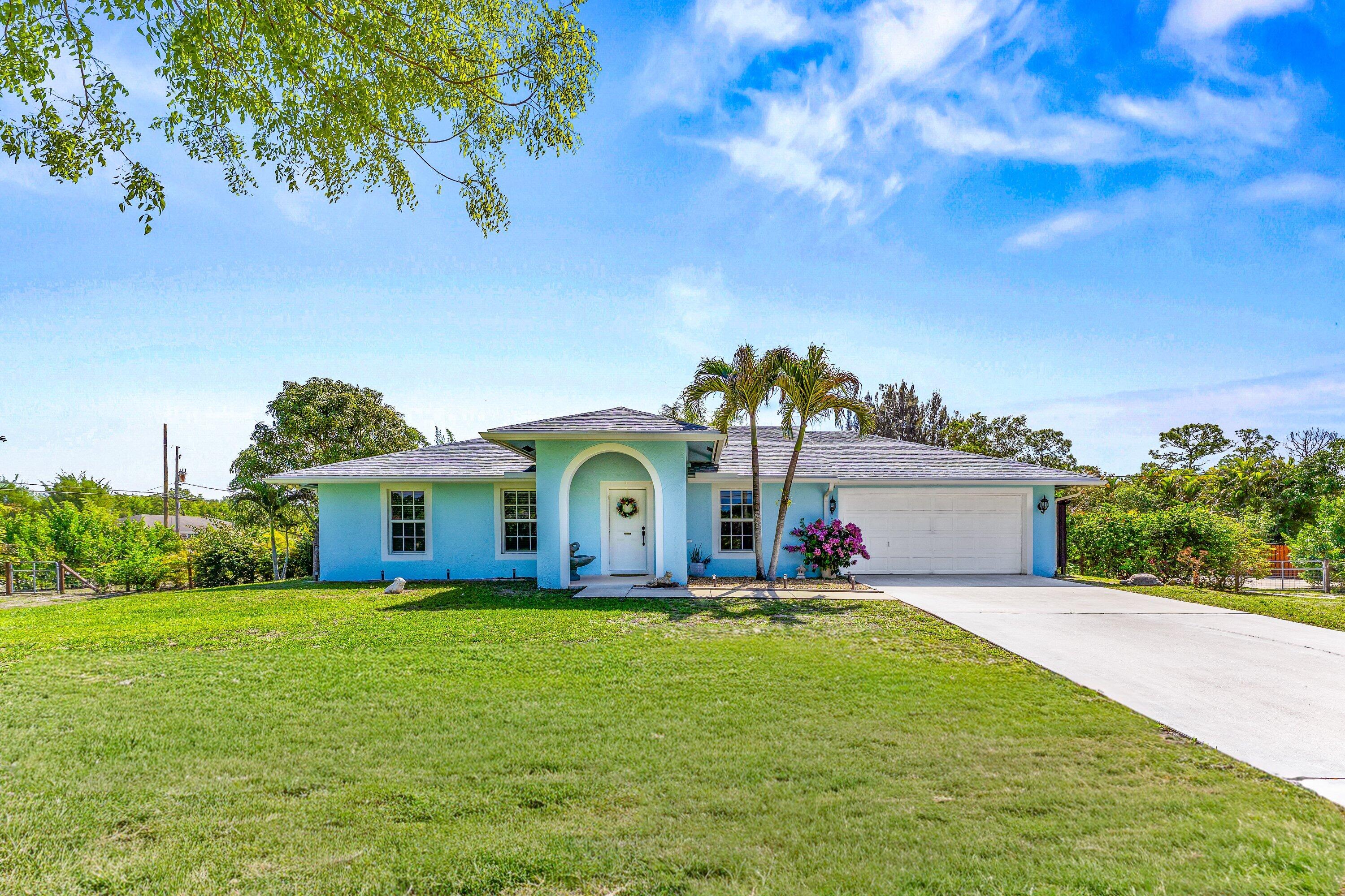 Beautiful 1.36 acre corner lot on paved road! CBS home with 2022 roof, gutters, impact windows, and French doors. This 3BD/2BA home offers a 2-car garage, fenced yard, basketball hoop, and an extended driveway perfect for extra vehicles or boats. Enjoy the 2024 hot tub and spacious patio surrounded by lush landscaping. Garage includes tile flooring, 2026 water heater, and 2018 A/C. Fresh exterior paint and solid construction make this home move in ready and low maintenance. A perfect blend of comfort, functionality, and Florida outdoor living. Great location close to Publix shopping center.