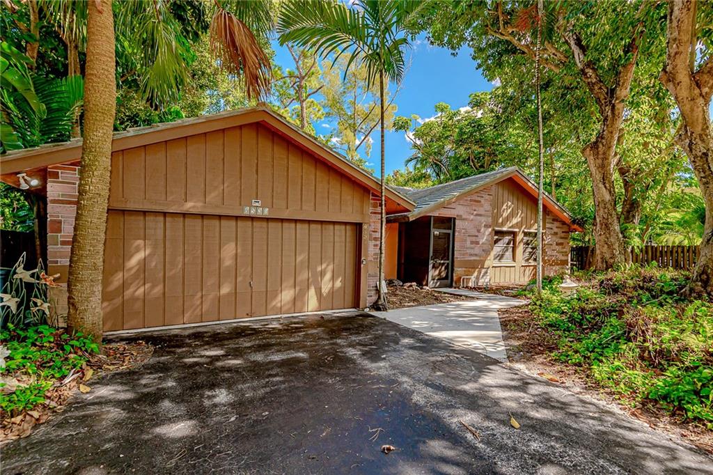 WOW THIS CORAL SPRINGS HOUSE MUST BE SEEN !! LARGE 4 BEDROOM 2 BATHROOM HOME ON A WOODED LOT !! KITCHEN OPENS TO LIVING ROOM !! GREAT OPEN FLOOR PLAN FOR ENTERTAINING !! TILE ROOF IN 2000 AND A/C IN 2015 !! LARGE LOT OVER 1/4 ACRE !! SCREENED IN LARGE OUTDOOR PATIO !! PRIVATE WOODED BACKYARD WITH 2 PRIVATE DECK AREAS !! FENCED YARD WITH AN  OVERSIZED POOL AND SPA !! X-LONG DRIVEWAY !! UNIQUE HOME WITH TREMENDOUS POTENTIAL !! NO HOA !! GREAT 4 BED 2 BATH POOL HOME