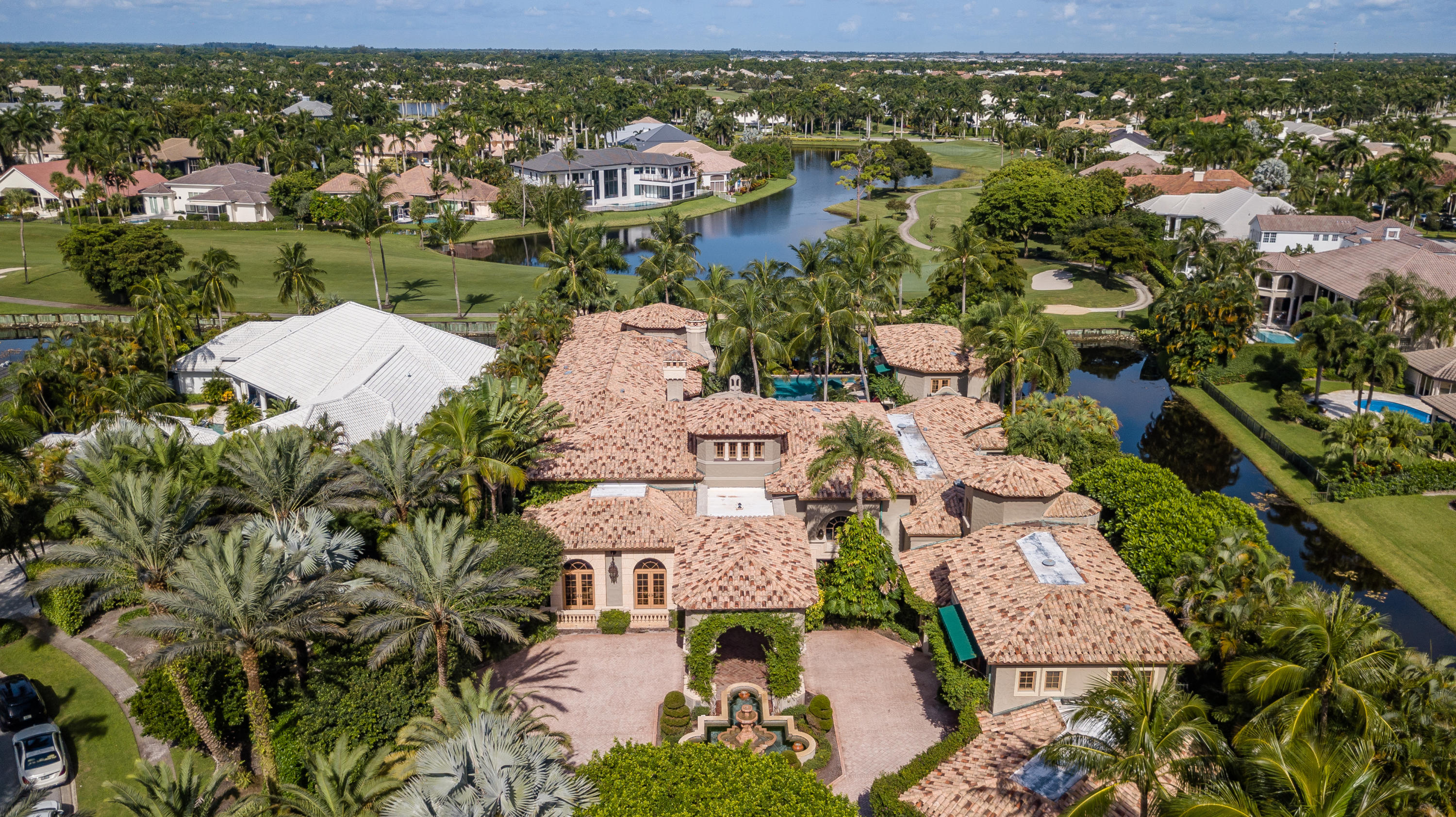 This iconic Palm Beach Estate was designed and built for grand entertainment and ultra privacy.  Set back on almost three quarters of an acre, a tropically landscaped motor-court is accented by a stately  portico of cypress cedar beams that leads to the main entry.  A raised foyer opens to a magnificent great room with views of the oversized pool, patio and gazebo areas.  The main floor features, a master bedroom suite with parlor, dual bathrooms and closet areas, full master suite office, exercise room, a classic club room office, formal dining, media, main kitchen and a back kitchen for live-in-staff.  The second floor features two bedroom suites, a billiard room, office, media room, and an outdoor veranda with bar. A two story guest house features two additional bedroom suites.  More... Description:  A Palm Beach Estate - St Andrews Country Club - Boca Raton Florida 
Impeccably designed estate on quiet cul-de-sac 
Double lot homesite 
Captures sunrise to sunset in privacy and tranquility amid a lush tropical paradise

Foyer: 
Marble floors
3 story Light tower with chandelier 
Marble grand staircase w/ wrought iron and wood rails. 

Great Room:
Marble fireplace 
Custom wood beam ceiling. 
Dual light fixtures 
Great room opens to an entertaining bar area 
Seating overlooking pool patio area. 
Bar has 2 refrigerators & ice makers

Formal Dining room:
Fireplace 
Chandeliers
Extensive custom ceiling mill work. 
Comfortably seats 20 

Media room:
Custom wood built in entertainment center. 
Accordion doors that enclose the area or open it up.


Main Kitchen: 
kitchen area & breakfast dinette area 
Hardwood cabinet. 
Jade marble counter tops 
Subzero refrigerator 
La Cournue  Gas stove 
Center island 
Walk in pantry 
Wall Oven and microwave 
Custom copper hood for cook's area. 
Herringbone pattern Spanish paver flooring
Connecting to dining room 


Staff quarters:
Fully functional prep and catering kitchen
Full laundry room
Staff powder room
Viking stove stop 
Refrigerator 
Granite counter tops. 
Tile floors through out 
Upstairs there are 2 Staff Bedrooms
Common sitting area

Guest House:
2 story guest house 
2 Bed/2 bath, living area and kitchenette
Pecky cypress cedar and ceiling and beams 
Outside shower. 
Separate loggia with cast stone columns
Walkway to lake and golf course 
Rear exposure is west 
Covered lanai 
Cabana bath 
Shower 
Separate laundry room / Washer and dryer 
Tierra cotta tile floors
 bleached and whitewashed pecky cypress wood 
Kitchenette with bar area. cook top and microwave, Sink and refrigerator. 
Media living room area overlooking the pool area. 
Upstairs bleached and whitewashed hardwood floors
2 en-suite guest rooms
Second floor balcony overlooking pool and golf course
Breezeway to outdoor entertainment area

Master suite:
Sitting/Sun room off master open to pool patio veranda
 Extensive custom mill work
Hardwood decorative ceiling beam work with fabric inlays
Fireplace with stone surrounds
Ceiling fan 
Her office directly off Master

Her bathroom:
Vanity make up area 
Walk-in shower 
Circular roman tub 
Accented with cast stone embellishments 
Water closet 
Frame less glass shower doors 
Her closet - fully fitted with abundant mill work, 2 stories, each measuring 30' x 15'

His bathroom:
Frameless Shower doors
Hardwood interiors
Water closet 

His closet:
Hardwood wood floors
Marble counter tops 
Custom wood cabinetry fully fitted with extensive storage

Gentleman's suite:
Billiards game room overlooking pool deck
Built in media armoire
His office with millwork cabinetry and ceilings
Hardwood floor with inlaid carpet
Pendant lights 
Fireplace 
Wet bar  coffee area with ice maker, refrigerator and microwave
Office bathroom. 
Large walk-in storage closet 
Media room seating 6 
Electronics stay and convey in 2nd His media room. 
Black out shades/curtains and dome shaped ceiling with light fixture. 
Media room leads out to fully finished 2nd story loggia
Loggia features covered bar and entertainment area ice maker, sink, refrigerator
Ceiling is pecky cypress with extensive beams. 
Outdoor light fixtures. 
Exterior chandeliers. 
Overlooks the pool, lagoon spa  very private 
Staircase that leads to the pool patio area. 
Connection to 2nd floor of Her closet. 

Main Floor Office: 
Oak floors with Jade marble inserts 
Extensive millwork with custom shelving throughout
Antler chandeliers covey
Powder room bath

Exercise room:
Home gym with connecting bathroom 
Outdoor patio off the exercise room has serene waterfalls
Patio area has cut coral floor.

2 Guest Bedroom Suites (upstairs):
2 full bedroom with en-suite full baths
Hardwood floors 
Carpet in the rooms 
1 suite with balcony. 
Both have walk in closets 

Resort Style Pool, Spa & Patio:
Largest pool in St. Andrew featuring fountains and full length lap pool area
full summer kitchen off the main kitchen. 
DCS gas grill with hood. 
Exterior refrigerators and Ice Makers.
Outdoor Entertainment bar 
Pecky cypress ceiling and beams 
Media center at bar area
Gas Fireplace 
Extensive marble pool patio floor
Entire house opens to pool patio area 
3 entrance areas to the pool. 
70 x 70 Pool 
70-foot lap lane 
Sun shelf 
Retractable sun awning off covered loggia/entertainment area 
Retractable screens to loggia/entertainment area 
Night lighting and outdoor speakers
5 Tropical electronic heat pumps. 
2 filters 
Pool heater  
Gas heater for the spa and waterfall lagoon. 
SW corner of property has a lagoon style pool and spa 

Exterior Entrance:
Dual paver entrance and exit circular driveway with covered portico 
Motor Court with Marble fountain showcases the front entry portico 
Entrance light columns approaching residence. 
Cast stone columns and cast stone privacy wall 
Grand exterior light fixtures 
Stately pecky cypress beam work
Walking path that leads to river rock waterfalls and babbling brook

Exterior/interior features:
Palm Beach style 14,000 sq.ft. estate 
4 car fully air conditioned oversized garage, plus golf cart areas  
Garage feature extensive built-in storage and walk-in pantries  
Copper gutters, leaders and drain spouts 
Full house generator
Impact windows throughout
12 separate air conditioning zones Featuring state-of-the-art Lennox equipment
Full house, exterior access termite prevention system 
Custom hand laid brick chimney 
5 home filter water filtration system for water softening
Iconic window awnings
Thin profile terracotta roof tile 
Crestron "smart home" media, entertainment, lighting and security systems
Elevator