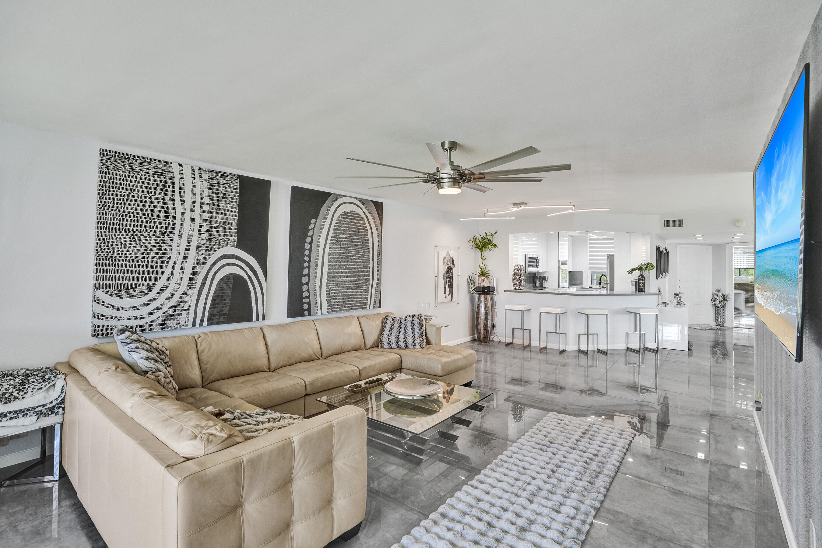 Nestled in the sought-after Island of Sunrise Lakes, just minutes from Fort Lauderdale's stunning beaches, this rare corner penthouse is the largest in the community and has been beautifully renovated top to bottom. Wake up to peaceful lake views and enjoy premium finishes throughout — porcelain tile floors, LED lighting, pull-out cabinetry, updated electrical, and stainless-steel appliances with a full-size washer and dryer. The third bedroom was reimagined as an elegant dining room with a built-in wet bar, perfect for entertaining, and can easily be converted back. Hurricane-impact windows with remote shades and a newer AC complete this stunning home. Resort amenities include a pool, gym, nine-hole golf course, theater, billiards, and more — all at no extra fees. Don't miss this one !