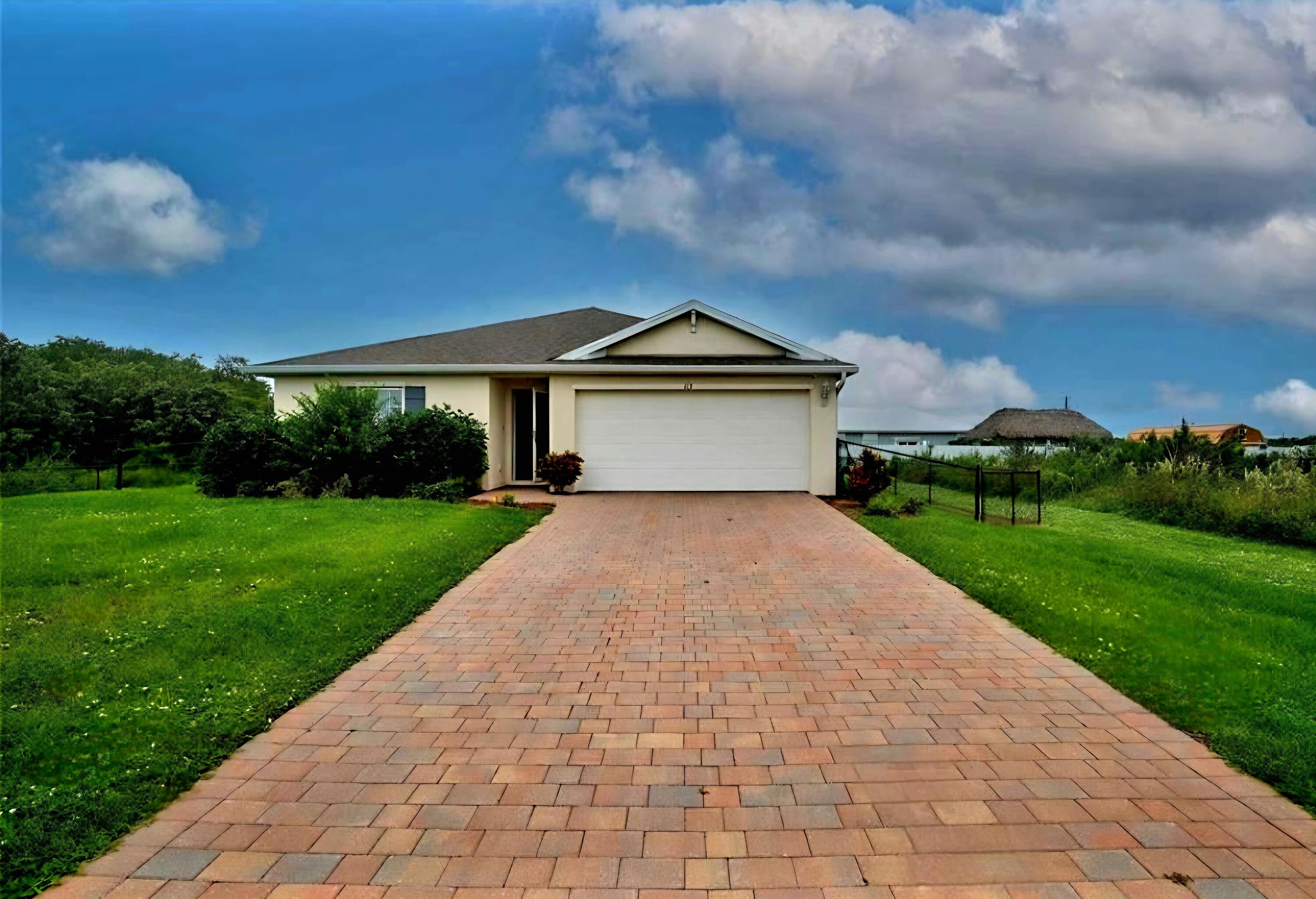 Truly a gem in the Heartland of Forida! This 2022 CBS property located in the peaceful Banyan Village neighborhood of LaBelle, Florida features 4 bedrooms, 2 bathrooms, a 2-car garage and sits on a large, fenced-in lot with a paver block driveway. The home offers an inviting floor plan with tiled floors, quartz countertops, storm-rated windows, and an ADT security system. This quiet community has NO HOA and it provides a perfect blend of country living for outdoor enthusiasts and business professionals alike. The location is just a short distance from the Caloosahatchee River and Hendry County amenities, with a DG conveniently located less than five miles away. Truly a gem in the Heartland of Forida!