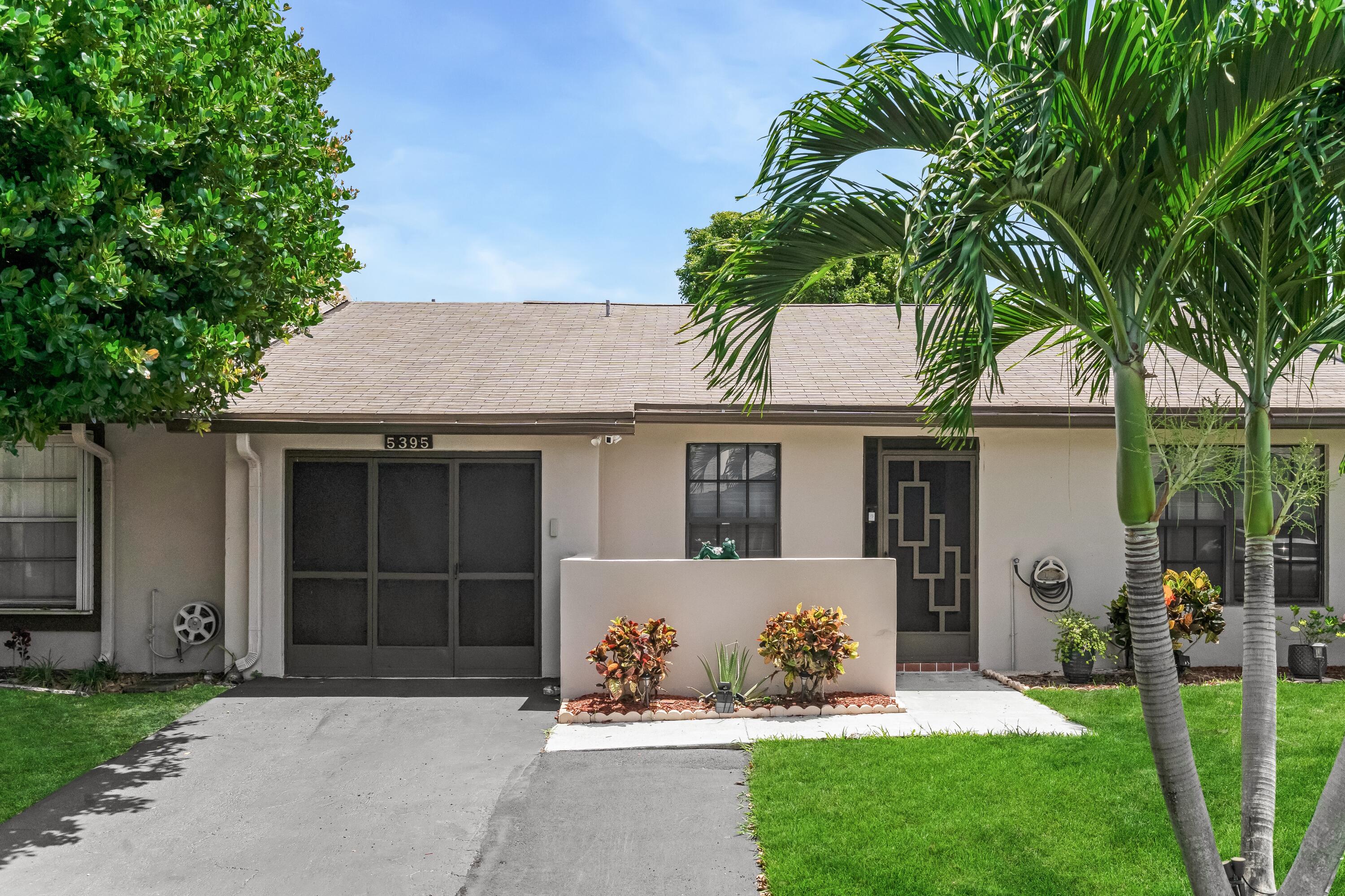 The perfect villa in Las Verdes, a 24-hour guard-gated 55+ community in the heart of Delray Beach!!! Inside is an updated open-concept white kitchen with granite counters and stainless steel appliances flowing into a bright dining and living area with vaulted ceilings and tile flooring throughout. Sliding glass doors extend the living space into an enclosed Florida room, both bedrooms offer generous closets and modern ceiling fans, and the master bathroom boasts new tile and a new vanity. Upgrades include: new garage door, new driveway, and a refreshed one-car garage with epoxy flooring and custom cabinetry. Outside, enjoy a screened front entry with private courtyard and a grassy backyard shaded by mature trees Just steps to the pool! Las Verdes offers resort-style amenities including a clubhouse, 3 pools with outdoor jacuzzis, tennis, pickleball, bocce, shuffleboard, basketball, handball, billiards, an exercise room, Zumba classes, library, and crafts, plus a lit central lake with fountain and half-mile walking trail all just 10 minutes to the beach. Move-in ready and waiting for you to call it home.