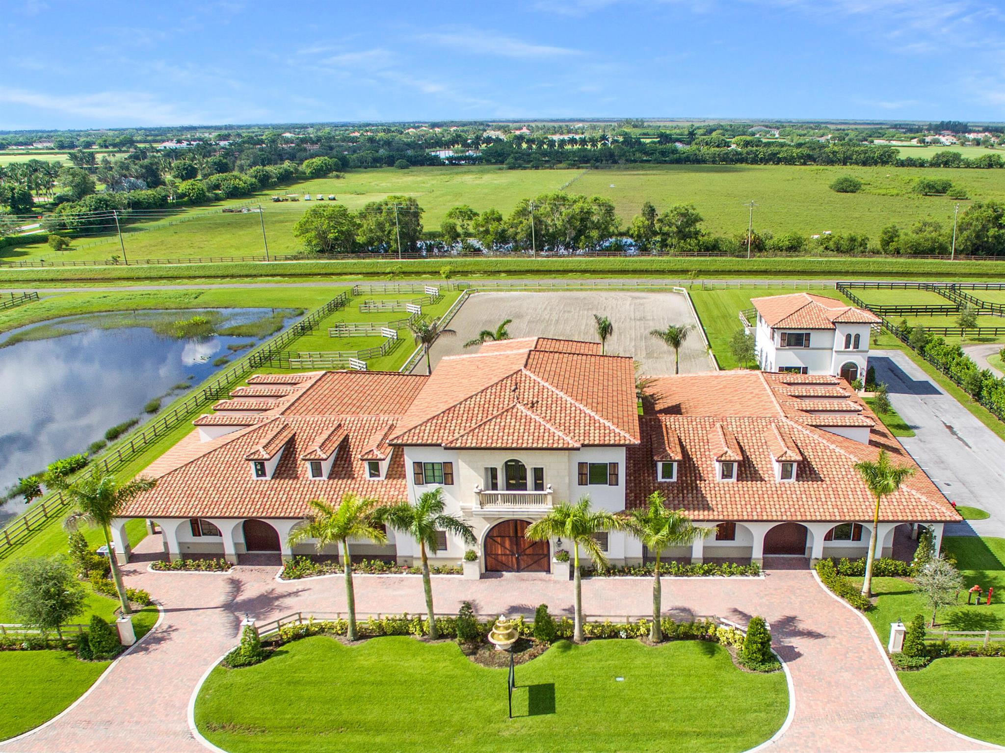 Location, Location, Location! Situated in the prestigious Grand Prix Village equestrian community next to the horse show this 3.66 acre 20 stall equestrian compound has it all. Near the new South Gate and adjacent the the Wellington International show ground expansion there is direct access to WEF on NO traffic or crossing busy roads. The barn has two (2) 10 stall center aisle wings 2 large tack rooms, 2 feed rooms, 2 large storage rooms, vet stalls, wash stalls, laundry, kitchen/snack bar area and office. On the second floor is the fully finished 1 bedroom Owners Quarters with both stair and elevator access. Perfect for entertaining with large a great room leading to the balcony overlooking the 120' X 210' riding arena and 7 paddocks. The second 2-story building includes a 2 bedroom apartment, 3 car garage perfect for jump and tractor storage and laundry. This is truly a MUST SEE Property!