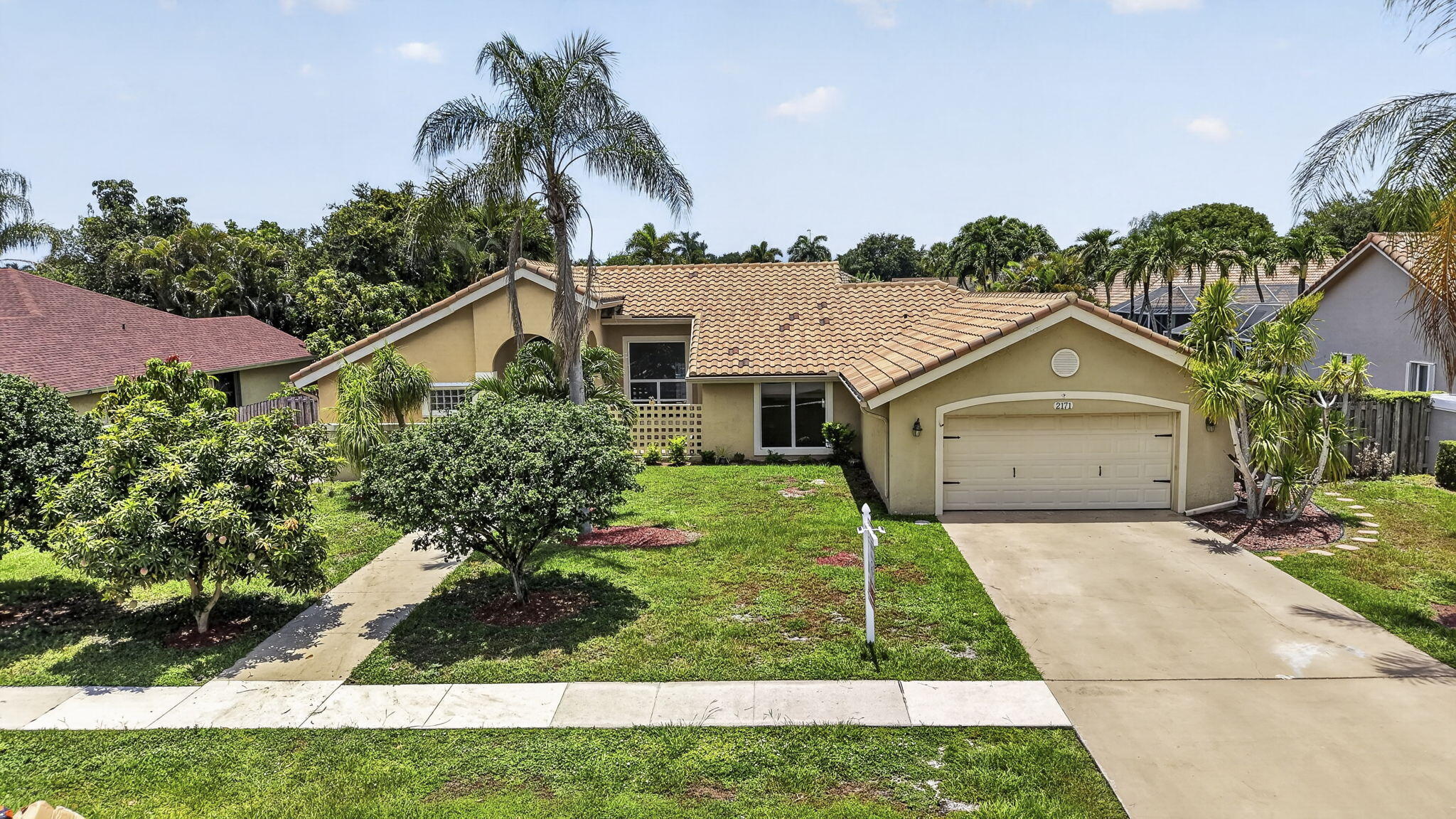 Welcome to this beautifully maintained 3-bedroom, 2-bathroom home with a 2-car garage. Ideally situated in the highly sought-after non-HOA Greenview Shores community of Wellington, this homes offers a spacious split-bedroom floor plan and generous living areas.  The home features full impact windows and doors, providing peace of mind and energy efficiency, along with a whole-home water softener and reverse osmosis system. The primary bathroom has been tastefully updated, while the open layout creates an inviting flow for everyday living and entertaining. Additional upgrades include added attic insulation, a newer flat roof, and a fully paved backyard. Located just minutes from Wellington International, Wellington Green Mall, top shopping and dining destinations, multiple parks, golf course s, and everyday conveniences, this move-in-ready home offers the rare opportunity to enjoy a highly desirable Wellington location with no HOA restrictions.