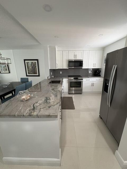 Step into style & comfort in this Move-In Ready, beautifully renovated 2-bedroom/2-bath condo in the heart of Dania Beach! This stunning residence showcases sleek tile flooring throughout  & a bright, modern white kitchen featuring quartzite countertops & brand-new appliances-perfectly blending elegance w/ easy maintenance. Enjoy peace of mind with major upgrades including a new water heater & new central A/C, while the open-concept layout creates a fresh, airy space ideal for today's lifestyle. Unwind on your screened-in patio overlooking a tranquil lake and sparkling pool! Ideally located just minutes from the beach, shopping, medical offices & major highways, offering both convenience & coastal living at its best.The building has reserves, assessments fully paid & low monthly fees!