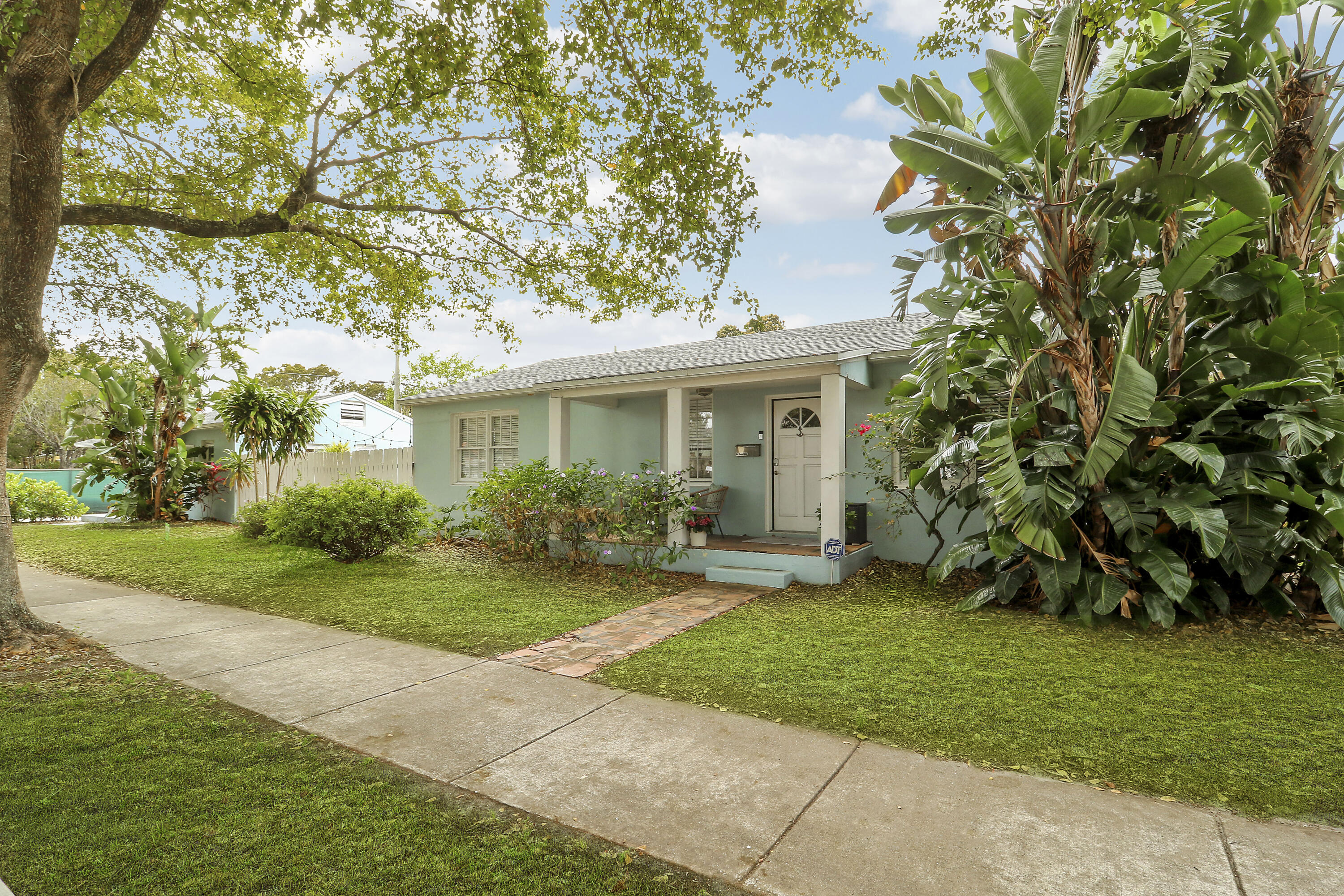 Fantastic opportunity in Old Historic Northwood to purchase a single family home with a detached cottage situated on a wrap-around corner lot. Both properties are CBS construction, have newer 2022 roofs with hurricane straps. The main house has 2 bedrooms, 1 bath, Central air & an attached garage. The detached cottage has 1 bedroom and 1 bath and wall unit air conditioners. The cottage has recently been renovated to include all impact windows, a newer kitchen, bathroom, appliances, newer hot water heater, insulation, washer, dryer and heat pump in 2023 as well as hardwood floors and was recently painted. The main house and cottage are provide the ability of independant living from one another including separate driveways and entrances. A lovely, fenced outdoor  covered entertaining area can be shared between the two. Centrally located this ideal West Palm Beach location is two blocks from the Intracoastal Waterway,  walking distance of Old Northwood shops and restaurants, a short drive to downtown West Palm Beach, Palm Beach Island, and 15-minute drive to Palm Beach Airport. A must see to appreciate.