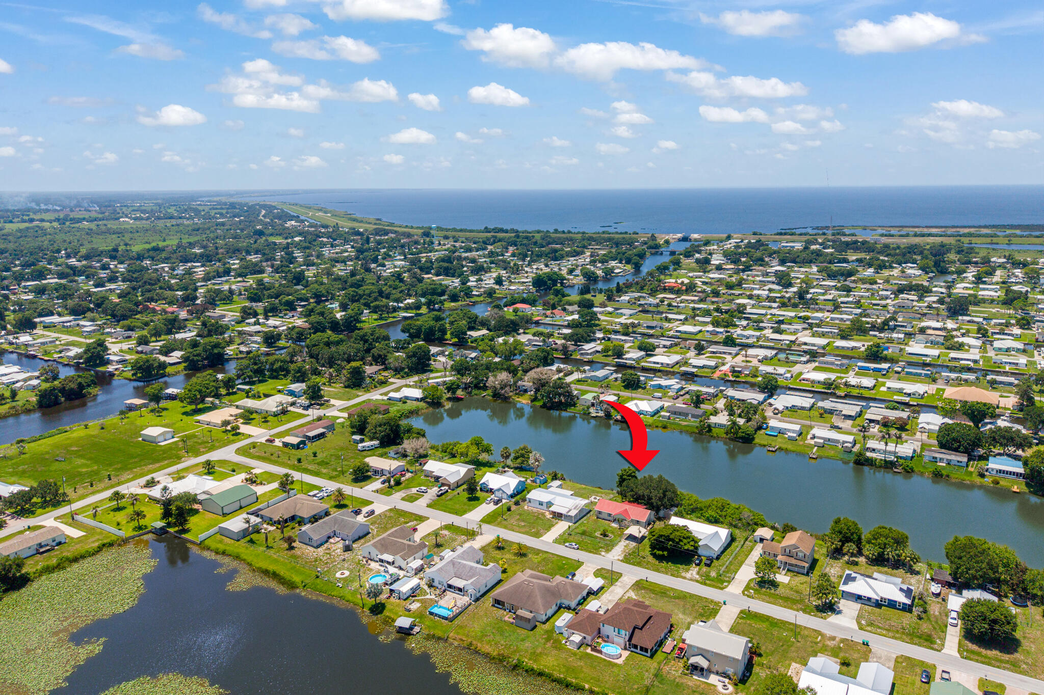 Enjoy the peaceful sound of the water from your rear deck all year round in this three-bedroom, two bath home. Okeechobee boasts some of the finest outdoor fun in Florida and this is the perfect place to begin and end the day! With a little updating this could be the perfect retirement, vacation, or full-time residence. Large open family room, and kitchen, separate laundry space, soaking tub in the primary suite overlooks the water, offering a relaxing way to end a day of fun in Okeechobee. Schedule to see this great home today! PLEASE DO NOT WALK ON THE DOCK SAFETY IS NOT GUARANTEED