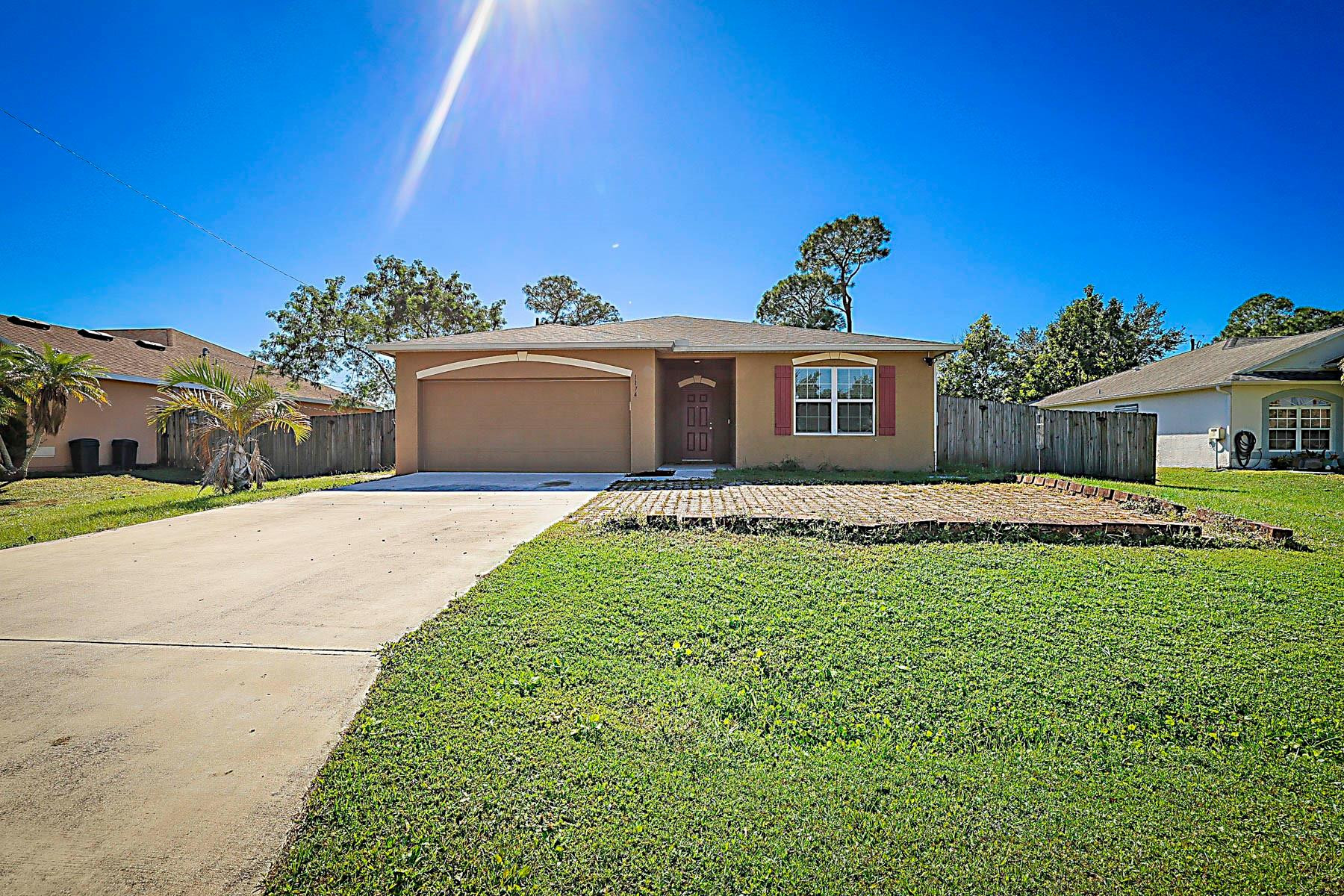 **NO HOA** Beautifully maintained 4-bedroom, 2-bathroom home with an open, split floor plan. Built in 2018, this home features granite kitchen countertops, GE appliances, a front flex room with built-in desk and shelving. Enjoy a dedicated laundry room with Maytag washer/dryer and a spacious 10,000 sq ft lot with side yard access large enough for a boat. The 2-car garage includes a hurricane-rated door. Major systems from 2018 include the A/C, water heater, and shingle roof. Zoned for desirable St. Lucie schools and located close to shopping, dining, and major roadways. (Since photos have been taken, entire interior has been painted and new flooring has been installed in 3 of the bedrooms)