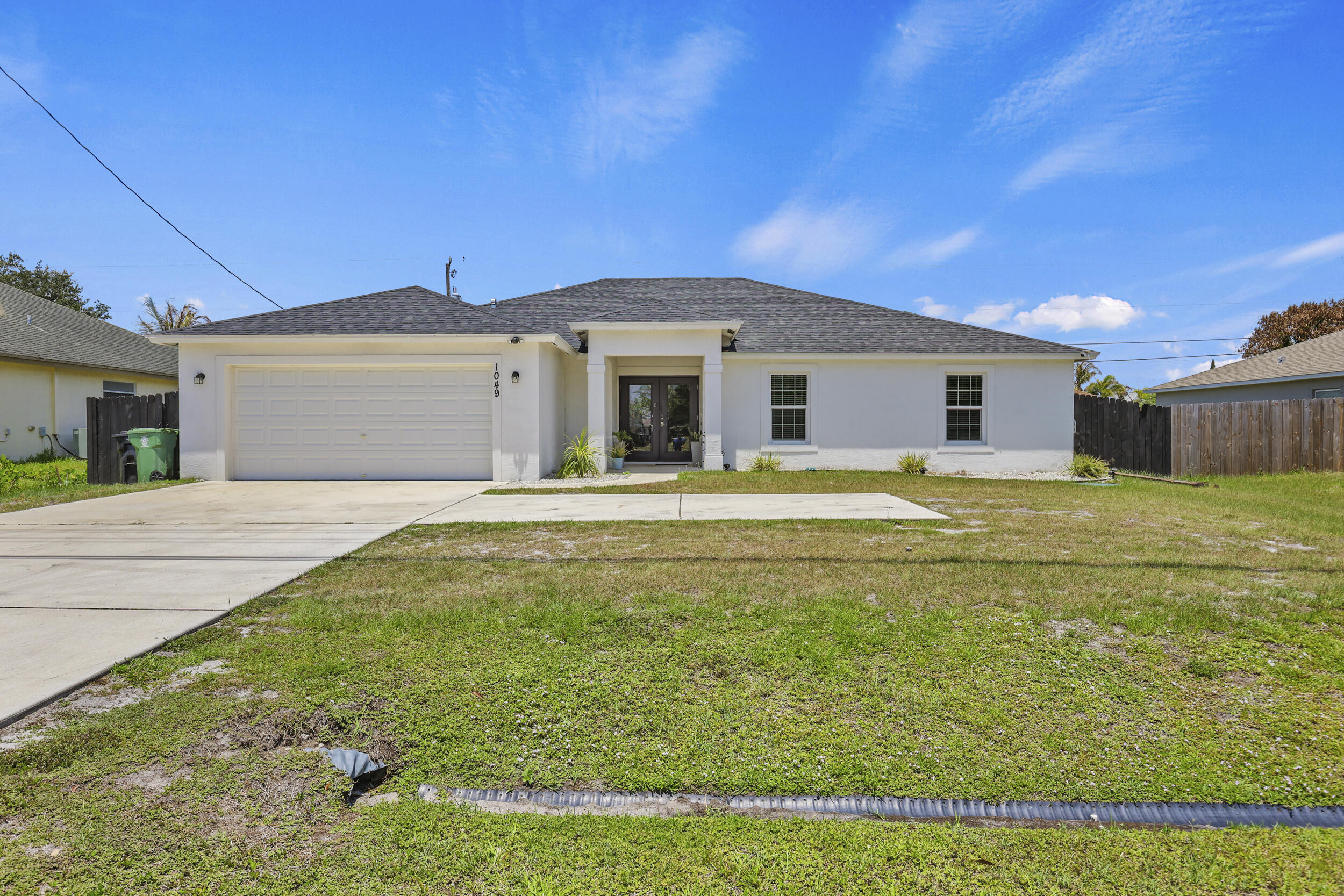 Beautiful CBS single-family home built in 2022, featuring 4 bedrooms, 2 bathrooms, and a 2-car garage. This modern open-concept floor plan offers spacious living areas, impact rated doors and windows, granite countertops, stainless steel appliances, and a large walk-in closet. The oversized primary suite provides a private retreat, complete with a spacious en-suite bathroom featuring a dual-sink vanity, separate soaking tub, and walk-in shower. Situated on a generous lot, the home includes a rear covered porch perfect for entertaining, a fully fenced backyard, and plenty of room to add a pool. Enjoy the comfort of newer construction with contemporary finishes throughout. Conveniently located near I-95, the Florida Turnpike, major shopping centers, restaurants,  and everyday conveniences, this home offers both comfort and accessibility. Don't miss the opportunity to make this beautiful home yours today!