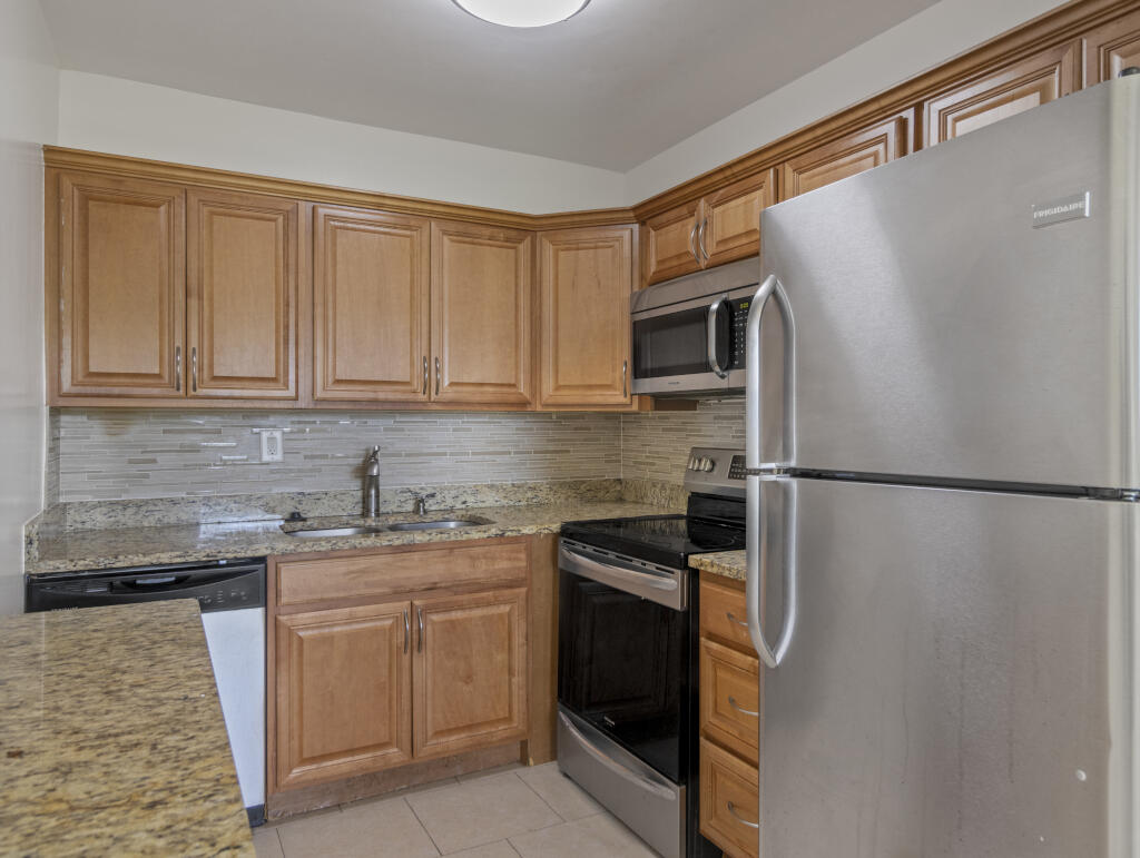 55+ COMMUNITY (HOPA). Beautifully renovated 2-bedroom, 1-bath residence offering refined living in the sought-after Century Village community. This thoughtfully updated unit features a stylish kitchen, elegant finishes, and a bright, comfortable living space designed for easy Florida living. Enjoy a true resort-style lifestyle with an exceptional array of amenities, including a state-of-the-art clubhouse, live entertainment, a 2,000-seat theater, fitness center, indoor pool, and an extensive selection of recreational activities such as tennis, pickleball, and bocce. Complimentary shuttle service provides convenient access throughout the community and to nearby shopping and dining.