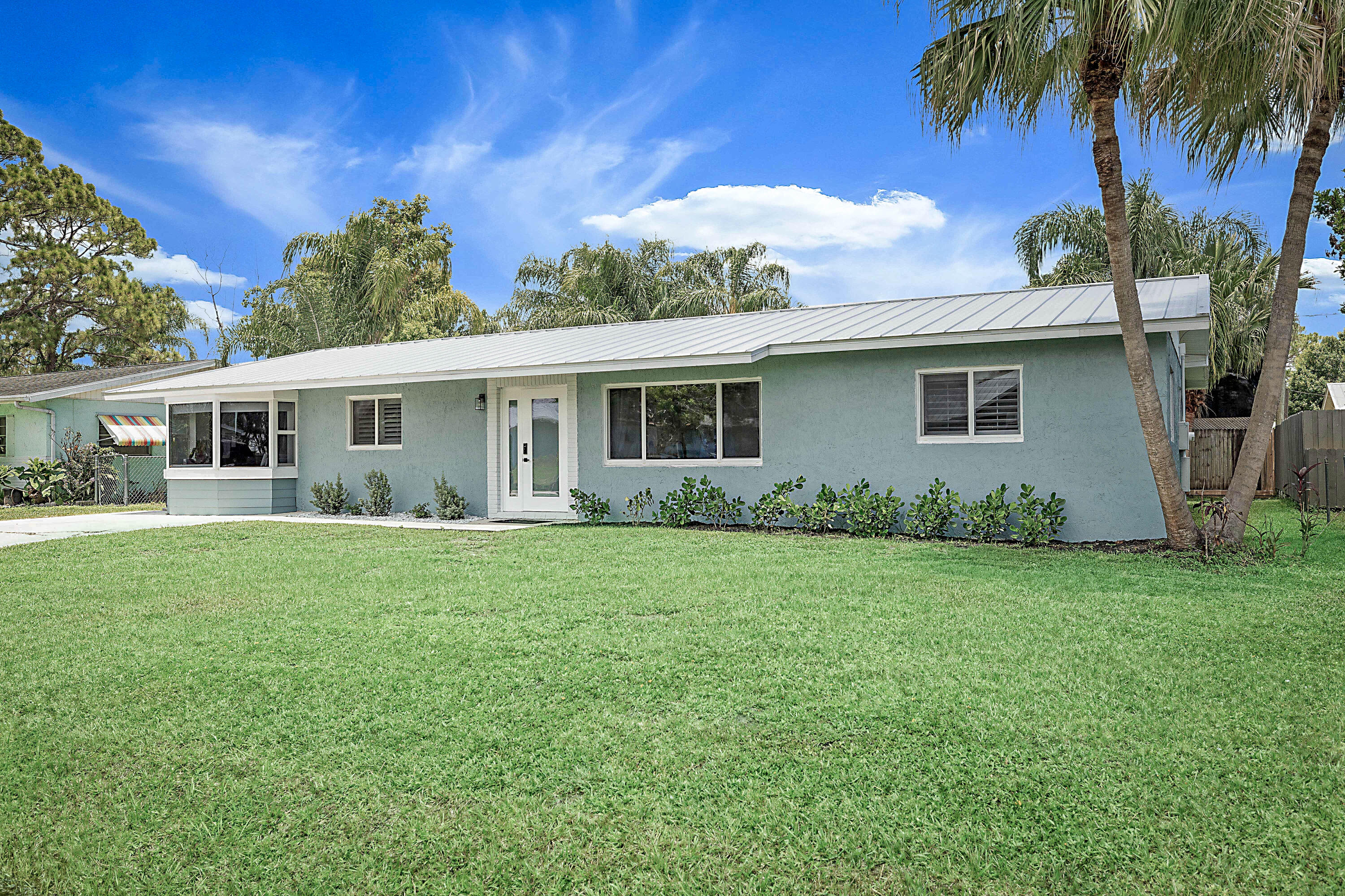 Welcome to 1851 SE Jackson Street, where timeless style meets modern updates in one of Stuart's most convenient locations. Offering over 2,500 square feet under air, this beautifully remodeled 4-bedroom, 2.5-bath residence combines generous living spaces with designer finishes throughout, creating a home that's as functional as it is beautiful.  The thoughtfully designed open floor plan provides exceptional flexibility for entertaining, everyday living, or multi-generational households. Every room reflects quality craftsmanship and meticulous care, making this truly move-in ready.  Enjoy lasting peace of mind with a new metal roof and new impact windows, while the spacious backyard—complete with an 8-foot privacy fence along the rear of the property—offers ample room to create your own out outdoor oasis.  Perfectly situated on a large lot, this home is just minutes from Stuart's beautiful beaches, shopping, dining, parks, and everyday conveniences, allowing you to enjoy the very best of Florida's Treasure Coast lifestyle.  An added benefit for future homeowners: the community is currently undergoing infrastructure improvements, giving residents the option to remain on septic or connect to the new public sewer system once available.  Beautifully updated, exceptionally spacious, and competitively priced for the neighborhood, 1851 SE Jackson Street is a rare opportunity to own a beautiful home with outstanding value in Stuart.