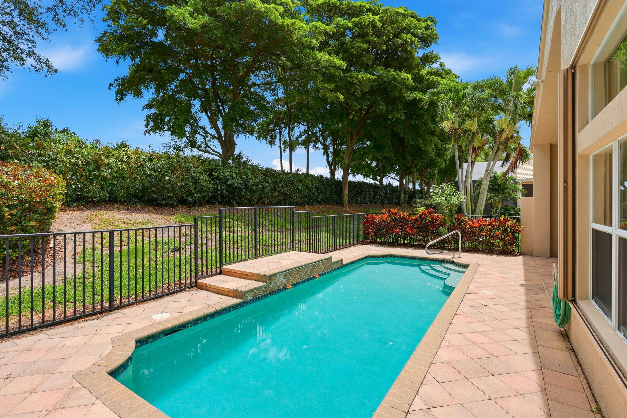 Highly desirable, beautiful Indian model pool home in Valencia Palms on a quiet private lot!  This home features a split bedroom floor plan, 3 bedrooms, 2.1 bathrooms. Large kitchen over looking the family room.  Formal dinning room with a sitting room. Laundry room, 2 car garage. High ceilings.  A private patio with a pool!! Newer A/C, New Blinds. HOA include ADT Security, Trees, Lawn, Sprinklers, Cable and Internet. 15 minutes to Atlantic Ave., 20 minutes to the beach. Shopping and entertainment close by.  Valencia Palms offers an active lifestyle including a spectacular 31,000 sq ft clubhouse, cafe, a resort style heated pool, state of the art fitness center. Tennis courts, Pickleball, Bocce, 24/7 guarded gate. Come see this large, light, bright home!!!