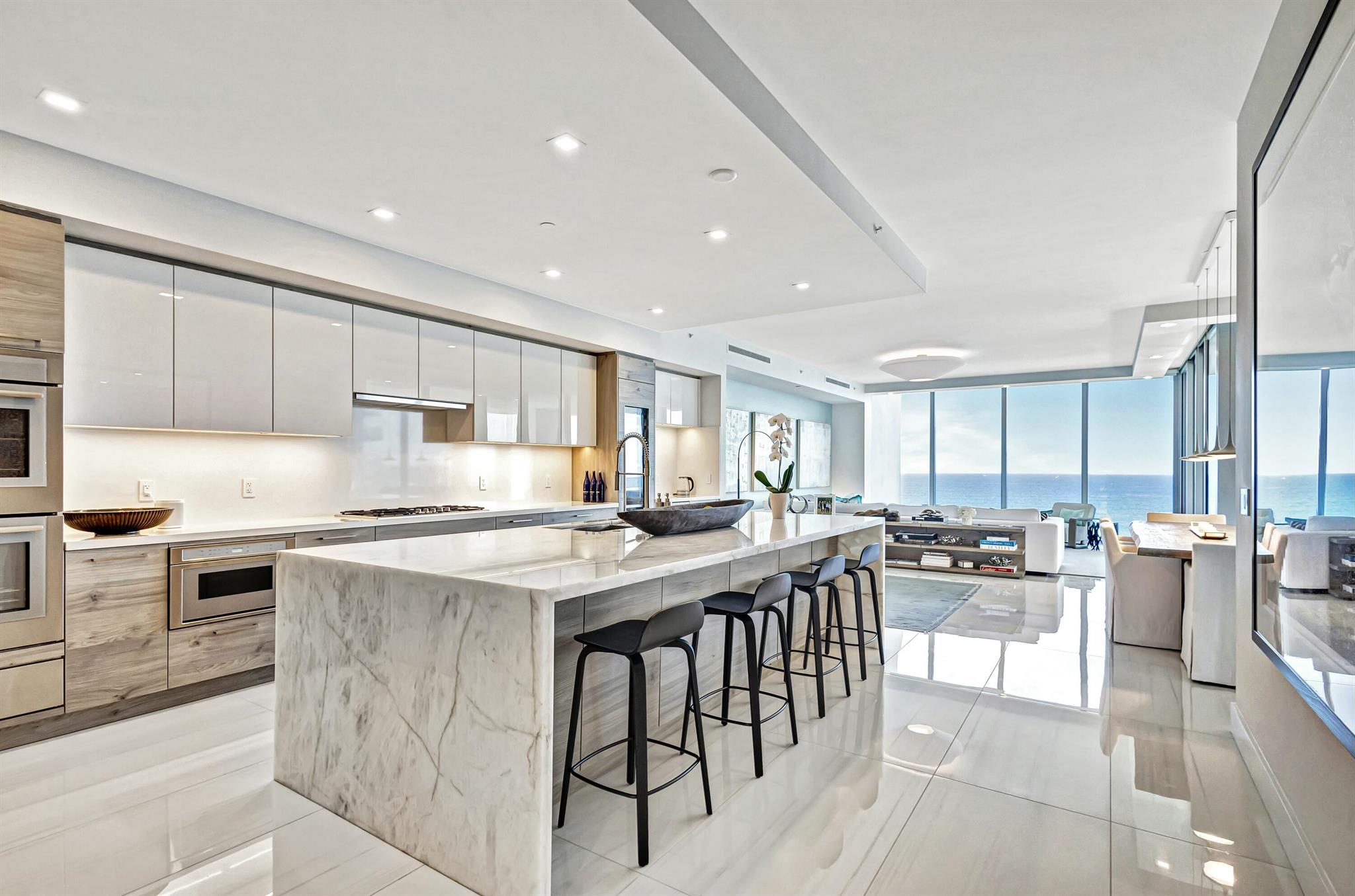 Your Private Beachfront Retreat Awaits! Experience unparalleled luxury in this stunning 3-bedroom + family room, 4.5-bath residence, boasting 3,753 sq. ft. of interior space in the exclusive 5000 North Ocean. As one of just 48 residences in this boutique building, this home offers the perfect blend of sophistication and serenity. Step off your private elevator into a modern, thoughtfully designed space with breathtaking ocean-to-Intracoastal views. The expansive southeast-facing terrace captures direct ocean views and overlooks 340 feet of pristine Singer Island beachfront, while west-facing terraces provide stunning Intracoastal panoramas and vibrant sunsets. Beautifully decorated and offered furnished, this residence is a showcase of modern coastal elegance. The gourmet kitchen features European cabinetry with advanced storage systems and integrated LED lighting. A stunning Cristallo Quartzite island with waterfall edges serves as the focal point, complemented by Quartz countertops and full-height backsplashes. Residents enjoy resort-style amenities, including a south-facing oceanfront pool bathed in sunlight all day, a secluded private beach, and a cabana lounge with cozy fireplaces, perfect for entertaining or unwinding by the shore. The state-of-the-art fitness center and club room provide additional spaces for wellness and social gatherings. A gated entrance with 24/7 front desk service ensures security and convenience, while three assigned parking spaces and a climate-controlled storage locker add to the ease of living. Located on the pristine shores of Singer Island, this sought-after oceanfront enclave offers effortless access to world-class dining, shopping, golf courses, and cultural attractions, making it the ultimate coastal retreat. Pet-friendly and designed for those who appreciate luxury, privacy, and breathtaking views, 5000 North Ocean delivers a sophisticated beachfront lifestyle.