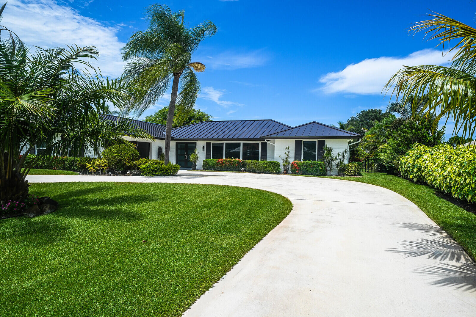 Nestled in the heart of Palm Beach Gardens, this masterfully reimagined residence offers a rare blend of sophisticated living and ultimate freedom. Situated on an expansive lot overlooking the pristine 18th fairway of the prestigious BallenIsles Golf Course, this exceptional property is uniquely positioned on a quiet, exclusive cul-de-sac with no HOA restrictions.  Delivering a true turn-key experience, every detail of this home has been meticulously updated for the discerning buyer. Architectural highlights include a striking new metal roof, a completely modernized HVAC system with all-new ductwork, full impact-glass windows, and bespoke interior design features throughout. The sprawling open-concept floor plan seamlessly flows into a chef-inspired island kitchen.  Offered furnished. Step outside to a private oasis featuring a covered loggia, a pristine screened pool, and lush, tropical landscaping complete with mature, producing avocado, lemon, and coconut trees. Absolutely nothing left to do but move in and enjoy the quintessential South Florida lifestyle.