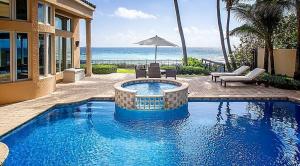 Palatial 6 bedroom oceanfront estate with dazzling panoramic ocean views in the highly sought after Ocean Place Estates in Highland Beach. Designed by acclaimed architect Tom Benedict, this seaside escape incorporates elegance with thoughtful functionality in an inspired transitional design. Over 9,000 square feet of gracious living on a high elevated site including a first floor guest suite/nanny quarters, two story grand foyer, oceanview salon with fireplace, private office/library with pecky cypress ceiling, and upgraded club room with full kitchen and bath. The gourmet kitchen with gas cook top, butlers pantry, and breakfast nook offers magnificent seascapes and opens up to a covered loggia, resort style pool, and your own pristine beach. All bedrooms have en suite baths, crown molding, and spacious outfitted closets. Wake up gently to the sound of ocean waves from your terrace or sun room off the spacious master suite. Equally impressive are the views from the 4th floor, a harmonious blending of aquamarine ocean stretching to crystal blue sky, making for a perfect retreat, a second master suite, or additional office. Luxurious touches include high impact windows and doors, private elevator, honed plank Saturnia in living areas, hardwood floors, commercial grade Internet access, and lighted, sculpted grounds. Ocean Place Estates is a private, gated community of just 11 residences on the sand in exclusive Highland Beach, the only 24-hour manned gated community on the ocean in South Palm Beach County. Minutes from the nightlife of famed Atlantic Avenue and the fine dining and shopping of Mizner Park in Boca.