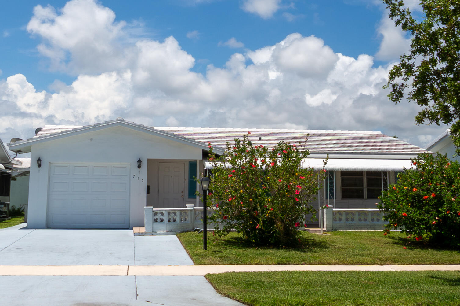 Welcome to this charming and well maintained 2BR/2BA Regis model home in the desirable Palm Beach Leisureville 55+ community. This single story home offers 1,317 sq ft of comfortable living space with tile flooring, bright living/dining areas, and a spacious Florida room. Updated kitchen features wood cabinetry, granite countertops, and tile backsplash, with modern vanities in both bathrooms. Major upgrades include a NEW tile/flat roof (March 2023) and NEW A/C (October 2025). Enjoy a covered front patio, 1 car garage, and a pre paid rec lease. Low HOA includes free golf on a private par 3 course, 3 clubhouses, pools, lawn care, and exterior painting. Ideal location near I-95, dining, and beaches. Schedule your private tour today! Welcome to this beautifully maintained and thoughtfully updated 2-bedroom, 2-bathroom Regis model home located in the highly desirable 55+ community of Palm Beach Leisureville in Boynton Beach. This inviting single story residence offers 1,317 sq ft of comfortable living space and blends classic Leisureville charm with meaningful modern upgrades that provide long term peace of mind. From the moment you arrive, you'll appreciate the home's clean exterior presentation, vibrant landscaping, and welcoming covered front patio—an ideal spot to enjoy morning coffee or evening breezes. Inside, the home features tile flooring throughout, creating a clean, durable, and easy to maintain environment. The bright living and dining areas offer excellent natural light thanks to large windows and an open layout that makes the home feel spacious and comfortable. A standout feature is the generous Florida room, which provides flexible additional living space perfect for reading, relaxing, hobbies, or entertaining guests. This room enhances the home's overall functionality and gives you multiple options for how you want to enjoy your space. The updated kitchen is equipped with newer wood cabinetry, granite countertops, a tile backsplash, and white appliances, offering both style and practicality. Both bathrooms have been refreshed with modern vanities, updated lighting, and clean finishes, ensuring the home feels well cared for throughout. Major improvements add exceptional value: a NEW tile and flat roof installed in March 2023 and a NEW air conditioner installed in October 2025. These upgrades significantly reduce future maintenance concerns and provide confidence for years to come. Additional exterior highlights include a one car garage and a covered front patio that provides a comfortable outdoor space to enjoy the Florida lifestyle. A notable benefit of this property is the pre paid recreational lease, which offers long term financial value and added convenience for the next owner. This is a meaningful advantage compared to homes that require ongoing rec lease payments. Palm Beach Leisureville is known for its unmatched amenities and welcoming atmosphere. Residents enjoy three clubhouses, along with heated/cooled pools, saunas, steam rooms, fitness facilities, hobby shop, shuffleboard, bocce, and numerous social activities. The community also features a private 18 hole par 3 golf course, and best of all—golf is free for residents. The low HOA fee covers lawn care, exterior house painting, access to all amenities, and golf, making Leisureville one of the best value 55+ communities in Palm Beach County. The location is another major advantage. Situated just minutes from I-95, shopping, dining, medical facilities, and the beautiful beaches of Boynton and Delray, this home offers convenience and lifestyle in equal measure. Whether you enjoy coastal activities, local restaurants, or easy travel access, you'll appreciate how centrally located this community is. The area also provides easy access to two international airports, making travel simple and convenient. This home is move in ready, well cared for, and positioned in a community that offers exceptional amenities and a friendly, active environment. With its valuable upgrades, flexible living spaces, and unbeatable location, this property represents an outstanding opportunity to enjoy the best of South Florida's 55+ living. Schedule your private tour today and experience the Leisureville lifestyle for yourself.