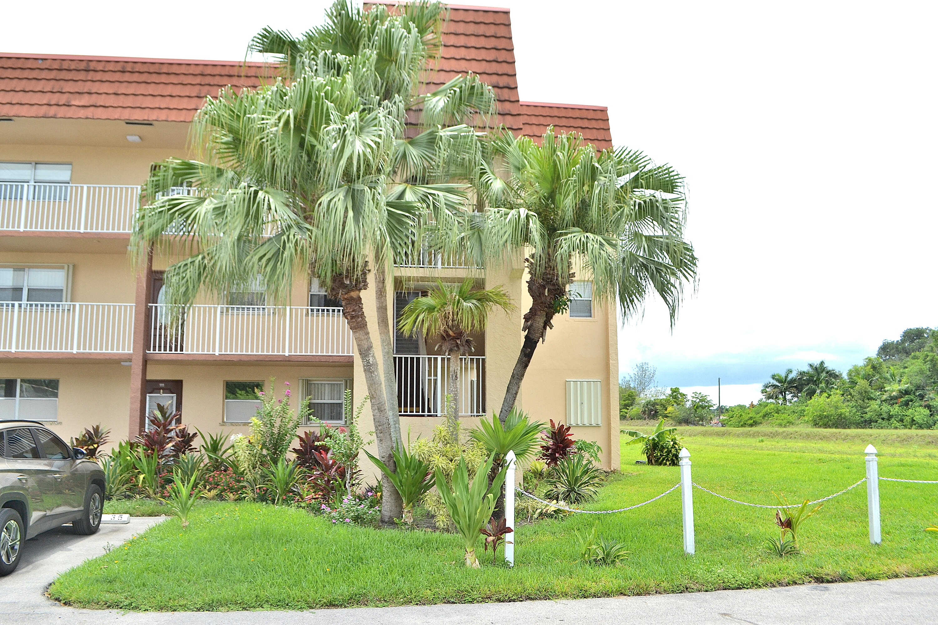 Welcome to this hard to find 2 bedroom 2 bath ground floor corner unit with extra windows for lots of light with an excellent location, very private and quiet. This highly desirable phase 3 residence spans 850 square feet of finished living space with updated kitchen and baths. Brand new impact $10K enclosed patio sliders. Newer AC 2023 and New water heater! This property presents an excellent opportunity for those seeking a turn key home. Community offers full amenities including transportation. This condominium represents a solid choice for buyers looking to drive up to their home with your parking space in front of the unit and lots of guest parking. Don't miss this opportunity!