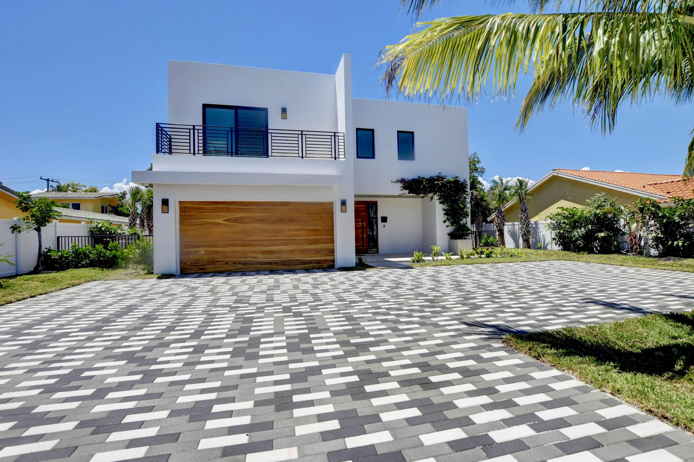 Luxury & Comfort in the heart of Boca! This 4-bedroom, 5-bathroom residence is a true sanctuary for modern living. The open-concept seamlessly connects the living & dining rooms with the chef-inspired kitchen. Large windows throughout the home flood each room with natural light. Upstairs, discover a grand club room, an opulent primary suite complete with designer walk-in closets and a luxurious spa-like bathroom, and two additional bedrooms with en suite bathrooms. Equipped with the latest smart technology, featuring a full home security system, Sonos sound system, motorized pirouette window treatments, heated pool and a whole house generator. Situated on one of the highest lot elevations in Boca Hills, it's just 3 blocks from the bustling Mizner Park and 2 miles from the ocean.