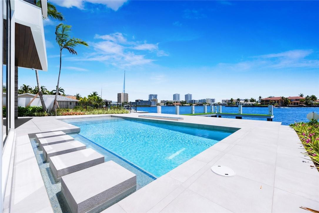 Move-in ready & newly completed! Modern architecture & wide open intracoastal views on Lake Santa Barbara! Surrounded by other new multi million dollar residences in quiet residential community close to shopping & dining on Atlantic Blvd.Enjoy stunning views from all 3 levels! 4 Bedroom Suites + Office/Gym + Club Room. Open great room & dining room wrap around the Chef's kitchen & breakfast area. Summer kitchen & expansive loggia to resort style pool. Elevator access & dramatic floating staircase. Level 2 offers Club Room & 3 bedroom suites. Ultra luxurious Master Suite with private balcony, spa bath, huge closets & private lounge/gym/den area. Custom pool design & concrete dock for multiple boats, jet skis, etc.