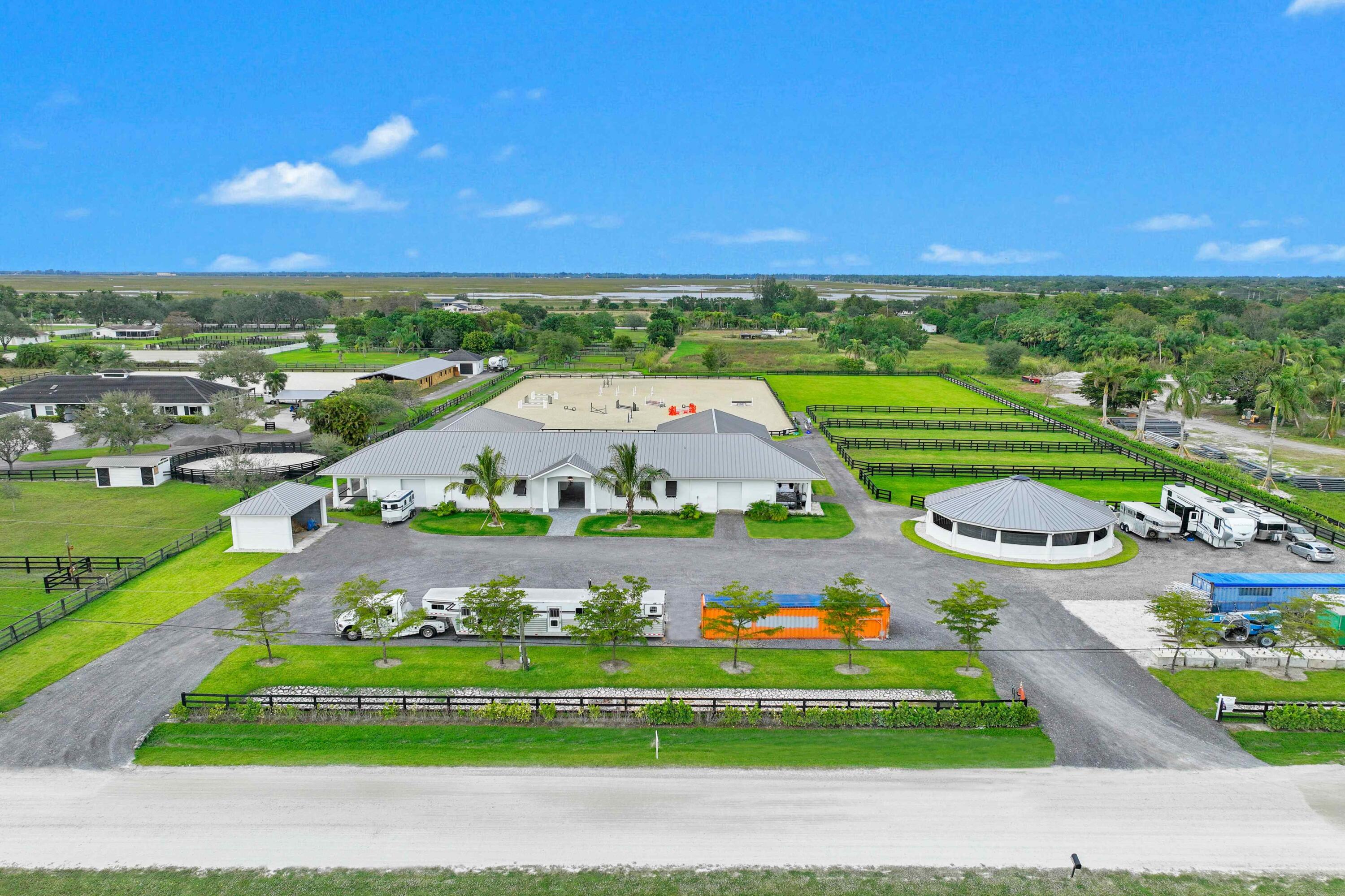 The future is here! This brand new 3D printed barn is one of the first of its kind, bringing luxury equestrian properties into a new era! This gorgeous facility offers 5 acres with 16 stalls, professionals arena, derby field and more. The expertly designed barn has an efficient layout which offers two private wings, each with 8 stalls, 4 covered wash stalls . There is a large tack and lounge room with a kitchenette, two half baths, wash room with ample storage space, storage and feed room with a storm roll-up door to make deliveries a breeze. All rooms have AC and all stalls and wash bays have high velocity fans. Riding amenities include a 250 x 175 Ebb and Flow sand arena plus a 175 x 125 grass riding field. There is beautiful state-of-the-art MK 6-horse walker and 4 irrigated paddocks. Enjoy easy access from two wide driveways plus ample parking for trailers and cars.

3D printing construction technology designed to be more durable, energy efficient and easier to maintain than traditional building methods. The barn is currently the world's largest 3D printed structure and offers all the common features of a top Wellington show barn, plus much more.

Seller financing possibly available