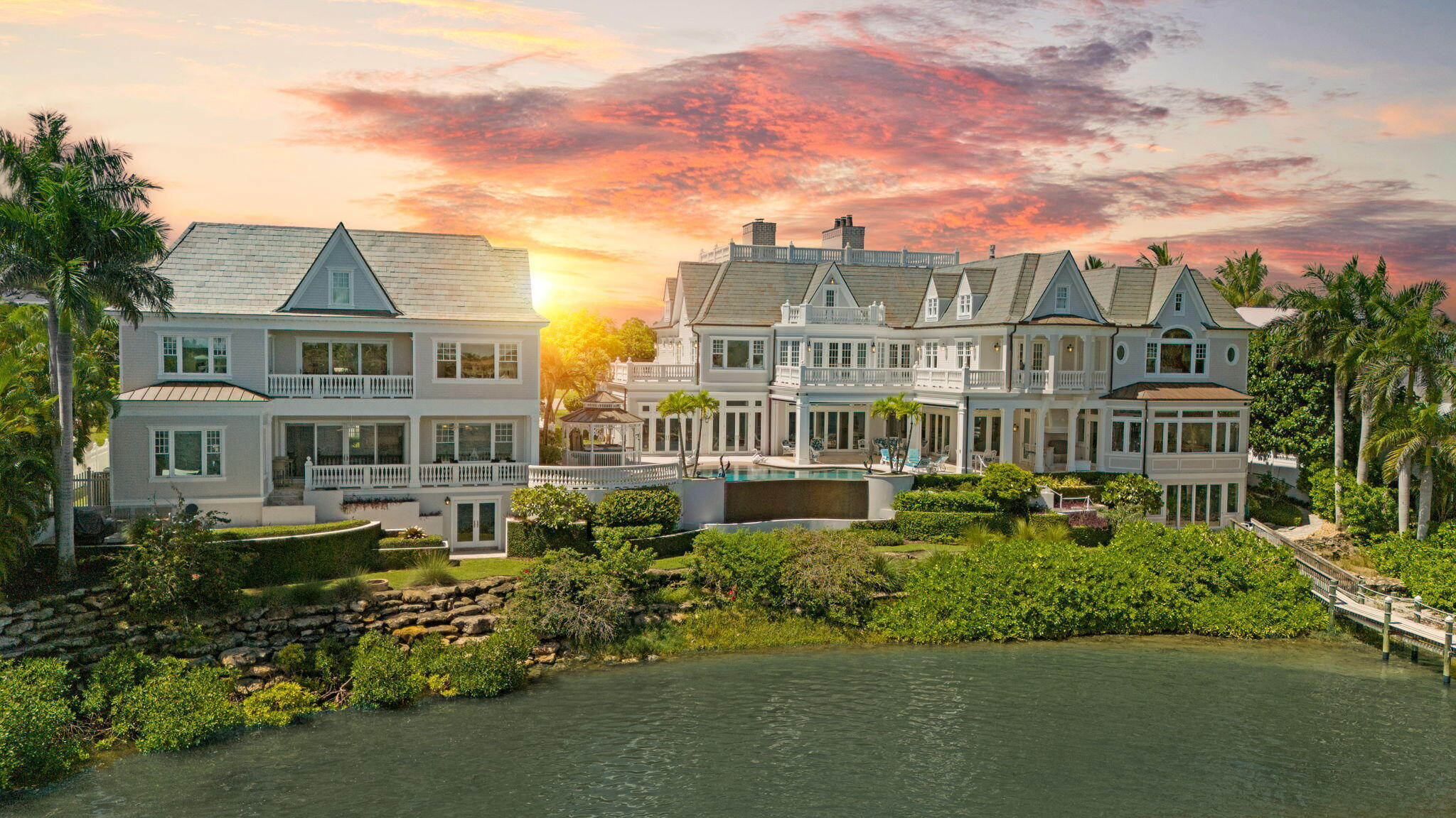 Welcome to Anglesea Estate, a refined waterfront sanctuary featuring 200' of elevated Intracoastal frontage and direct access to the Jupiter Inlet. Built in 2016, this estate was strategically designed to maximize panoramic water views through expansive glass and precise positioning. The main residence integrates classic European architecture with modern coastal finishes. Notable details include custom millwork, a Carrara marble fireplace, Murano chandeliers, and a chef's kitchen with dual walk-in pantries. The primary suite is a true retreat with dual en-suites, generous walk-in closets, and a private fireplace. An elevator services all levels. Outdoor amenities include an automated screened veranda, an infinity pool and spa, and a full-house generator.  For the mariner, the property offers a 140' dock with a 16,000 lb lift and a large moorage area on a protected no-wake stretch. The estate is further enhanced by a separate 3-bedroom guest house, private office suites, and flexible use spaces. With no HOA and dual zoning, the property offers rare versatility. Located minutes from the Jupiter Hills Club and the area's premier PGA-caliber golf courses and marinas.
