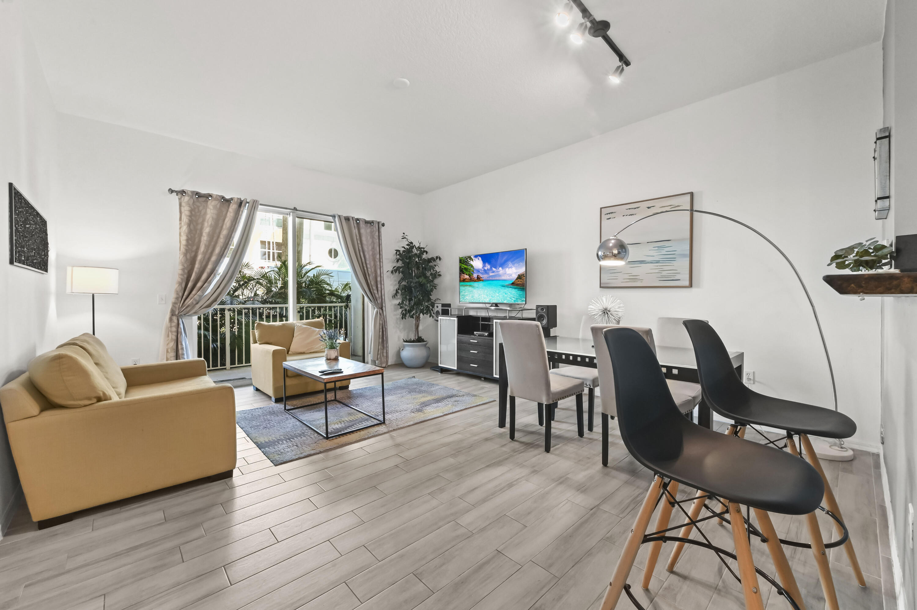 Discover your perfect retreat in this stunning first-floor, garden-view condominium, offering a unique blend of elegance and convenience. Step inside to an inviting open floor plan, enhanced by impressive high ceilings that create an immediate sense of spaciousness and light. The unit's prime location provides easy access to both the building entry and the garage. You'll enjoy modern comfort with a newer air conditioner and the convenience of an in-unit washer and dryer, making daily living effortless. 30 day minimum rentals allows a great income opportunity! This residence is part of a magnificent complex situated directly on the Intracoastal Waterway, offering a lifestyle of luxury and leisure. The community boasts its very own private marina, two sparkling pools, a sophisticated clubroom, a conference room, and a fully equipped gym. For your peace of mind and convenience, the building provides valet service and 24-hour security. Perfectly located just minutes from fine shopping, diverse dining options, and a wealth of other attractions, this well-maintained community offers an array of resort-style amenities that truly elevate your living experience.